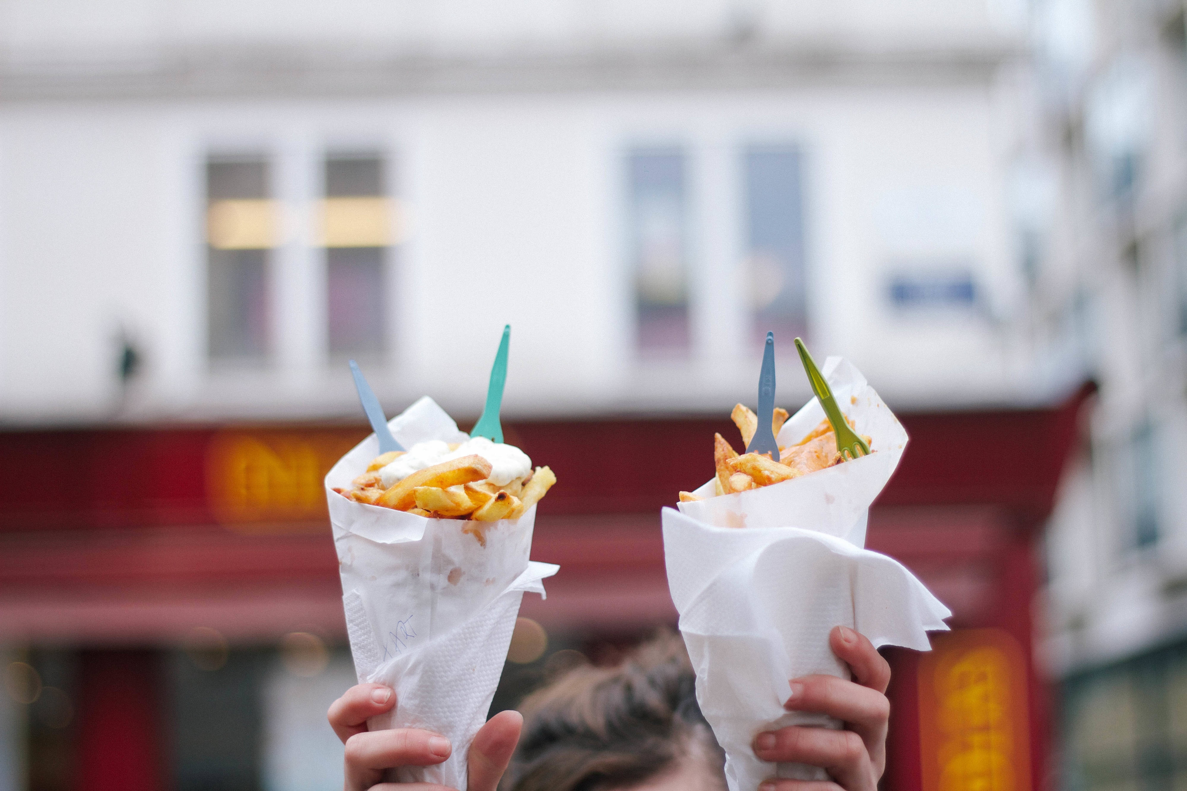 Person holding Belgian fries