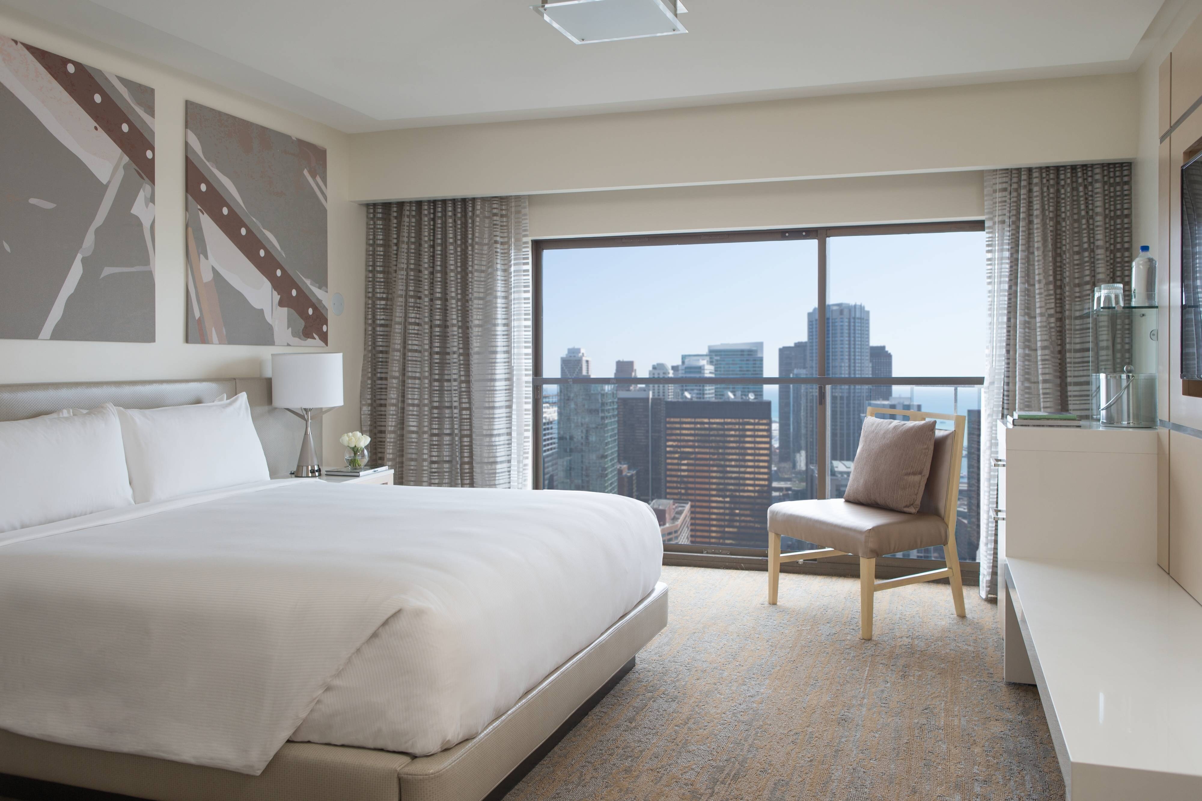 Suite with floor to ceiling window and city views