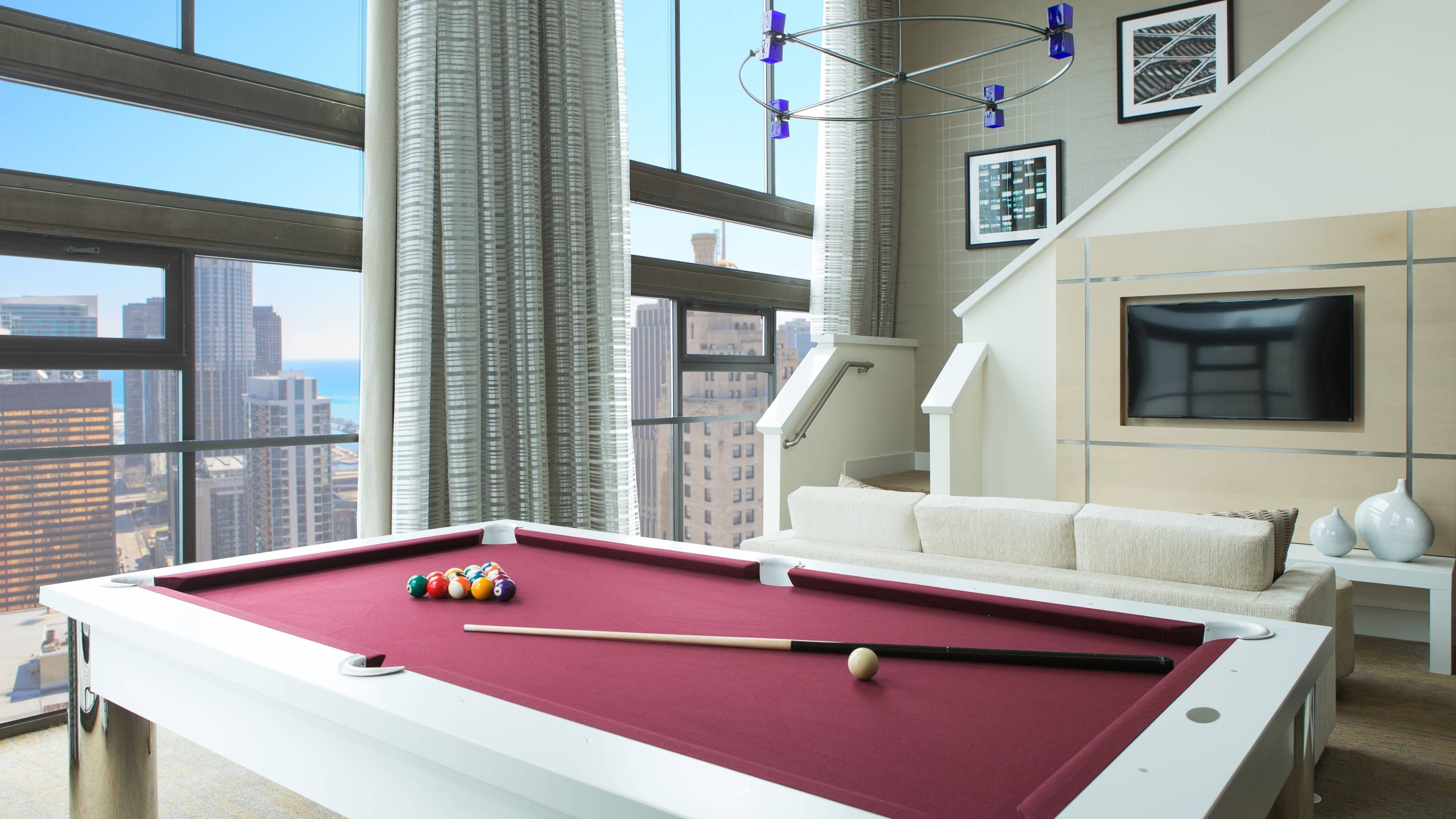 Suite with floor to ceiling windows and pool table