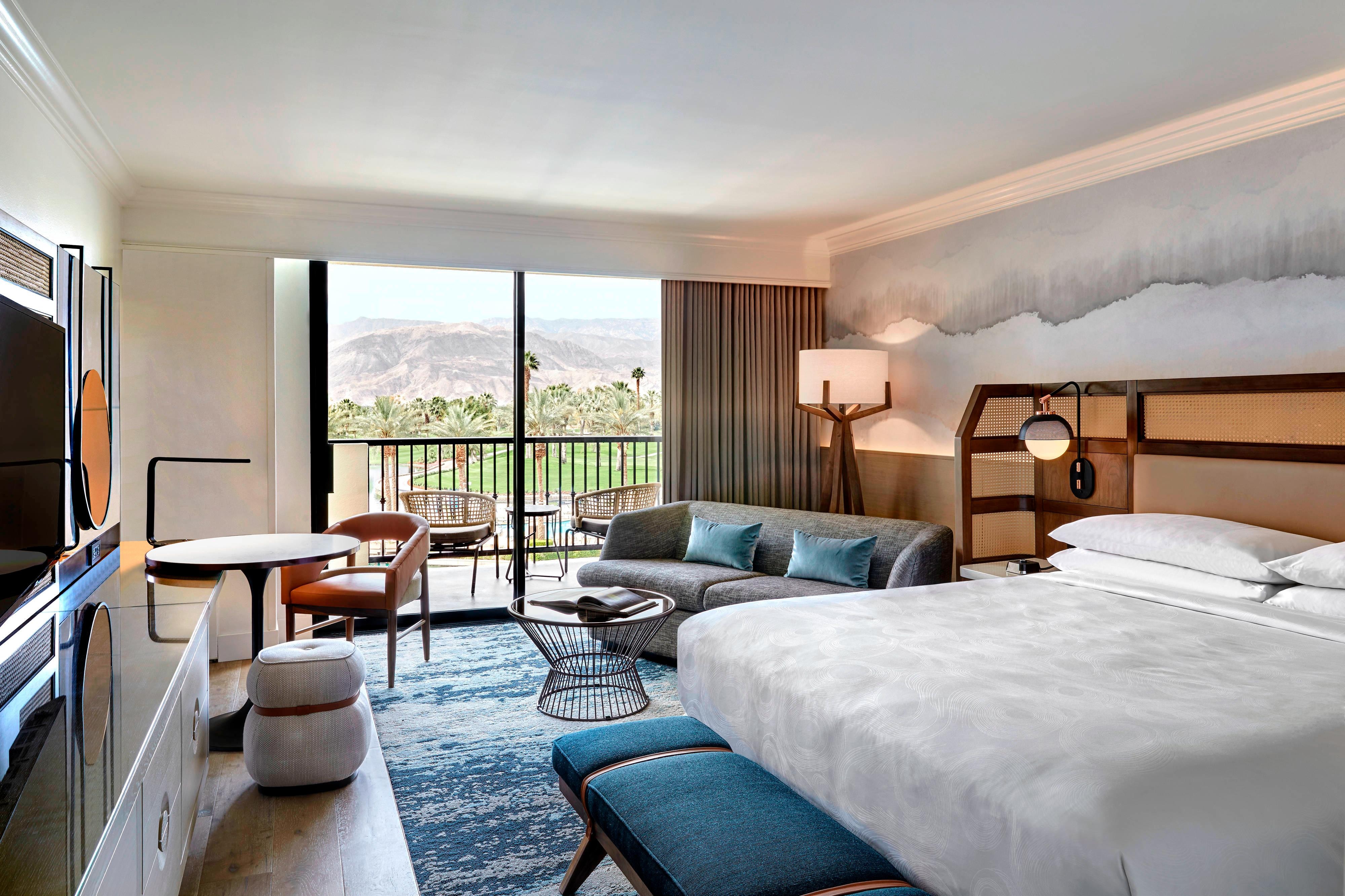 Guestroom with king bed, couch and balcony