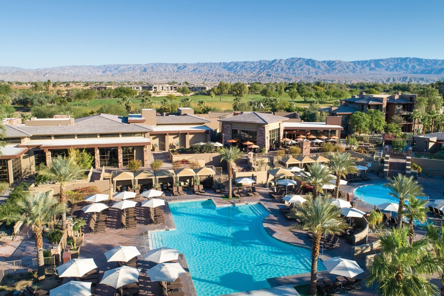Aerial pool angle with view of cabanas and other amenities.