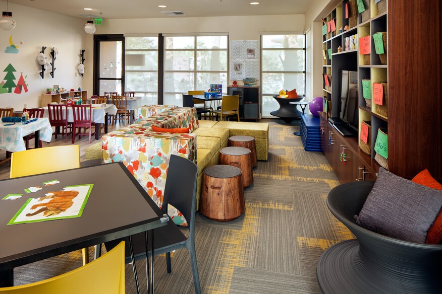 The Kids Club area, with activity tables, bookshelves, and other seating.