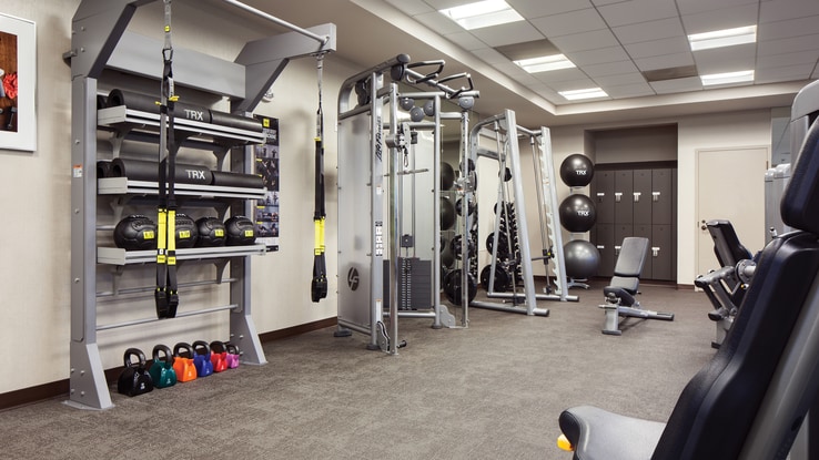 Small gym with fitness equipment.