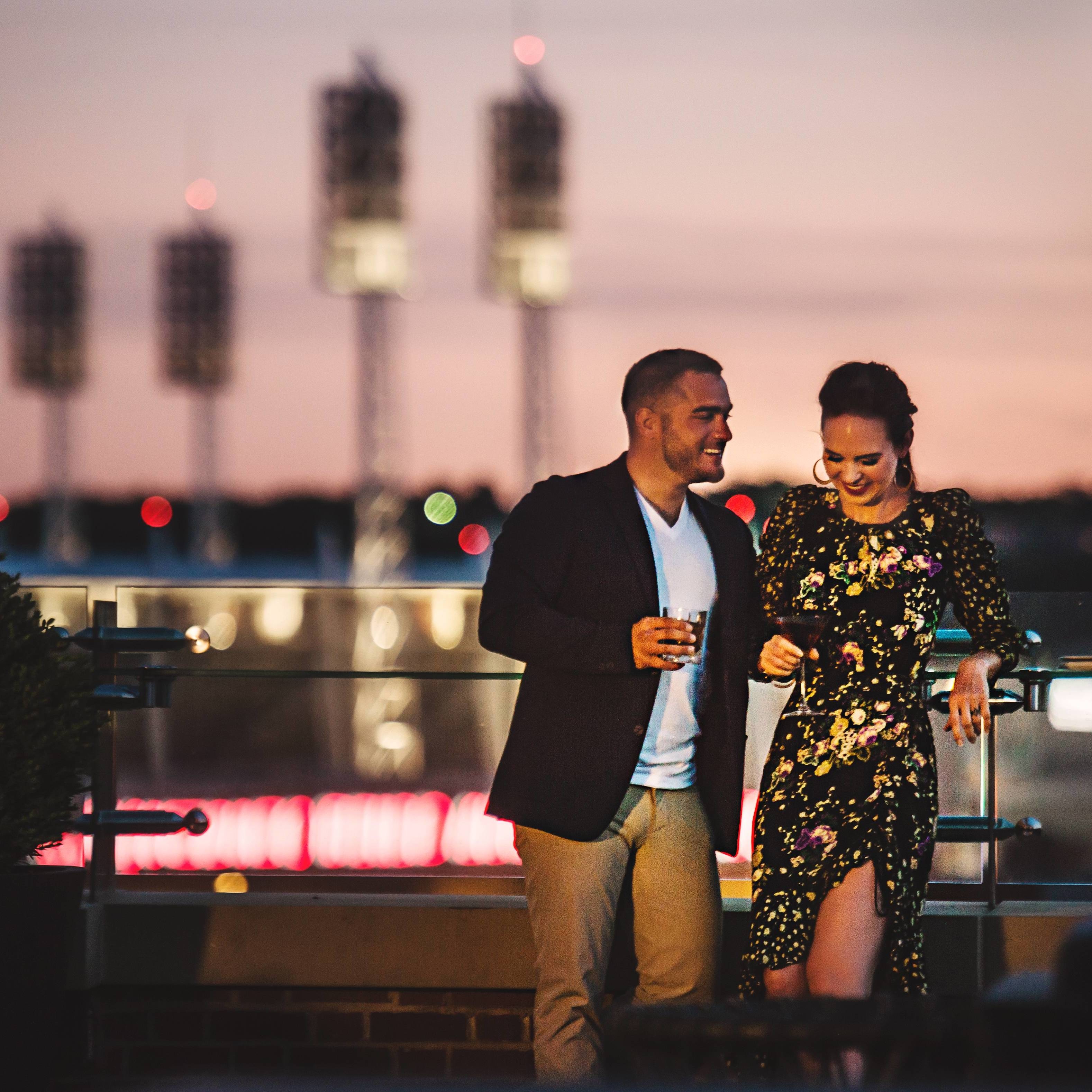 Couple sipping drinks at rooftop bar