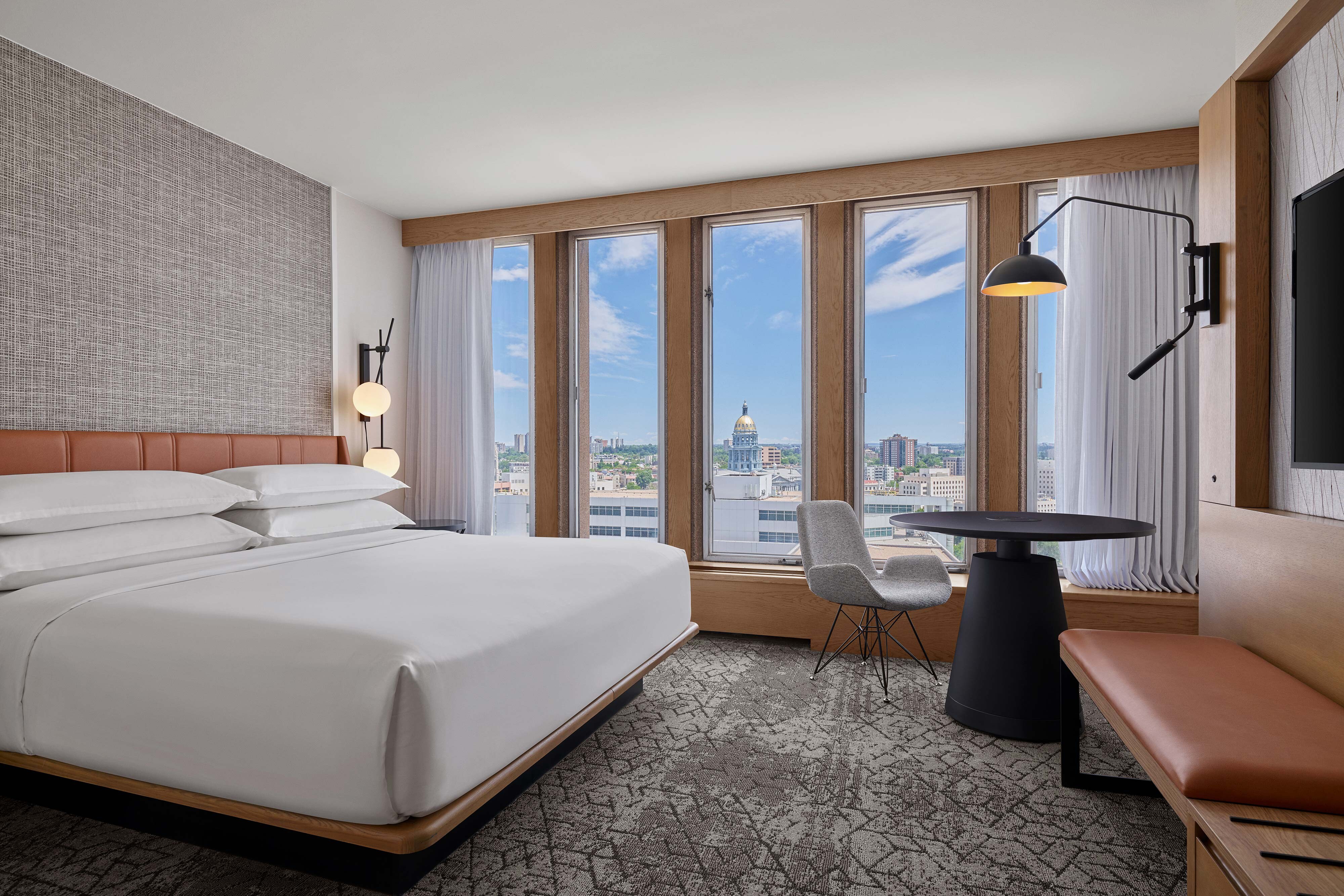 King bed with large windows and city view