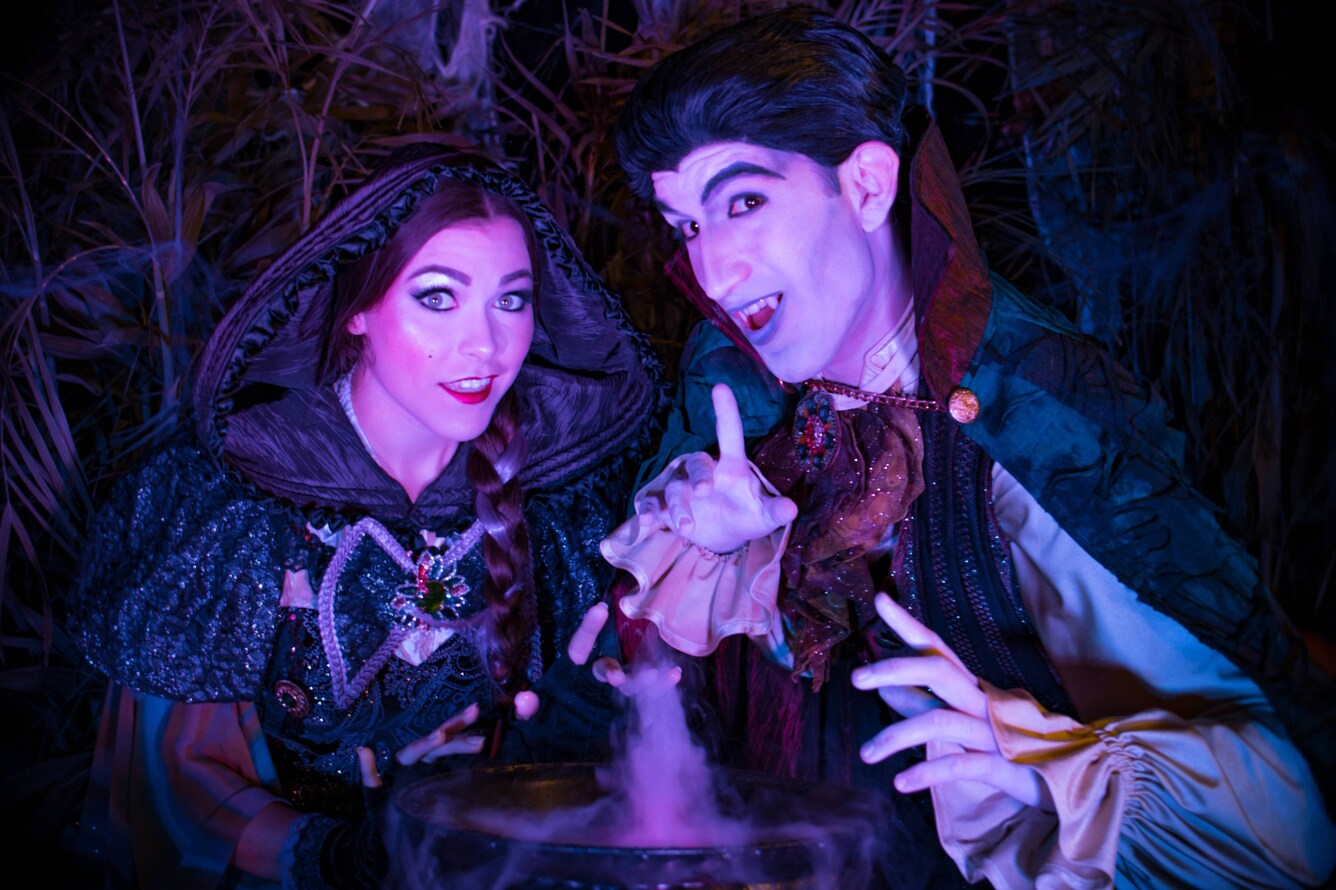 Actors dressed as a witch and a vampire.