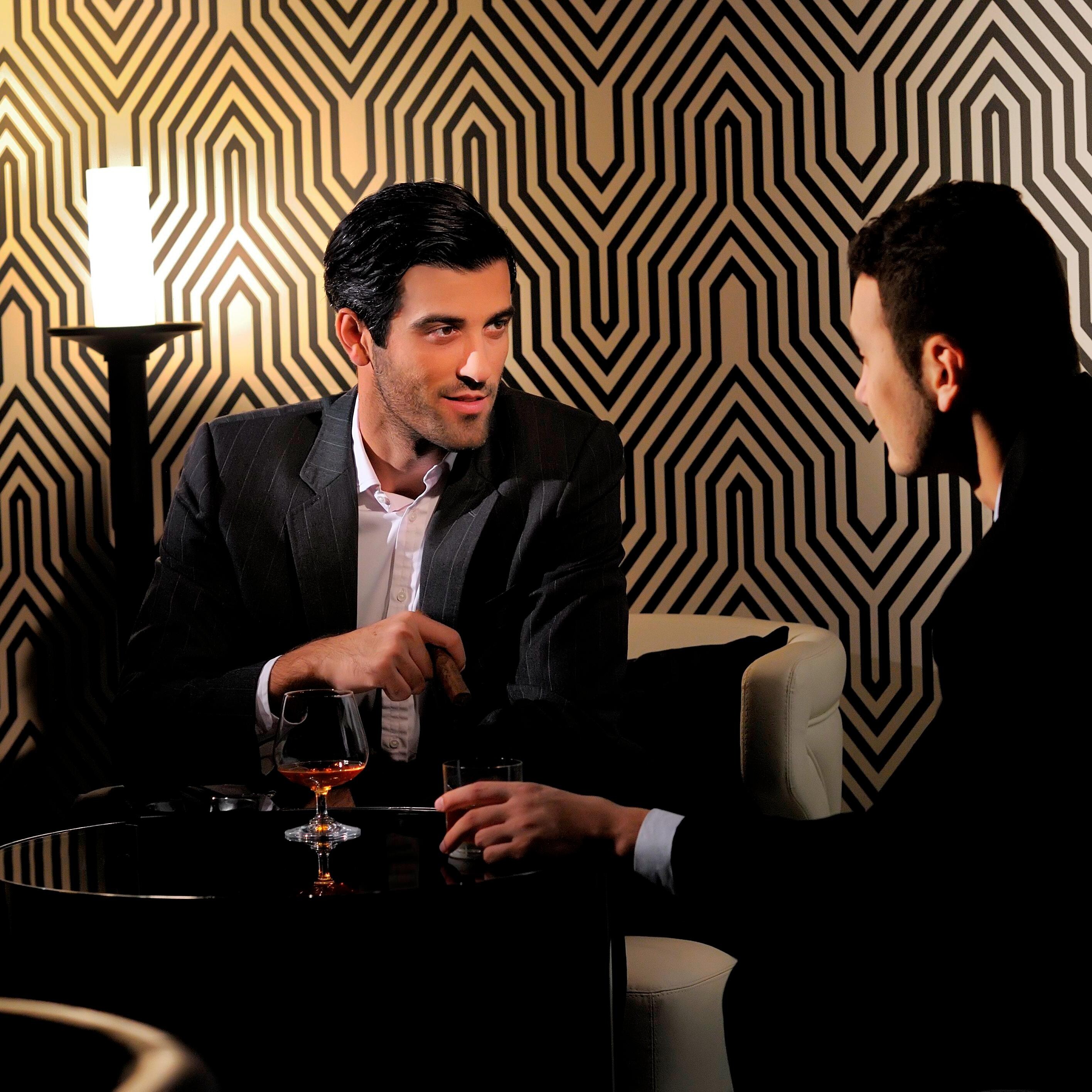 Two people conversing at a table with drinks