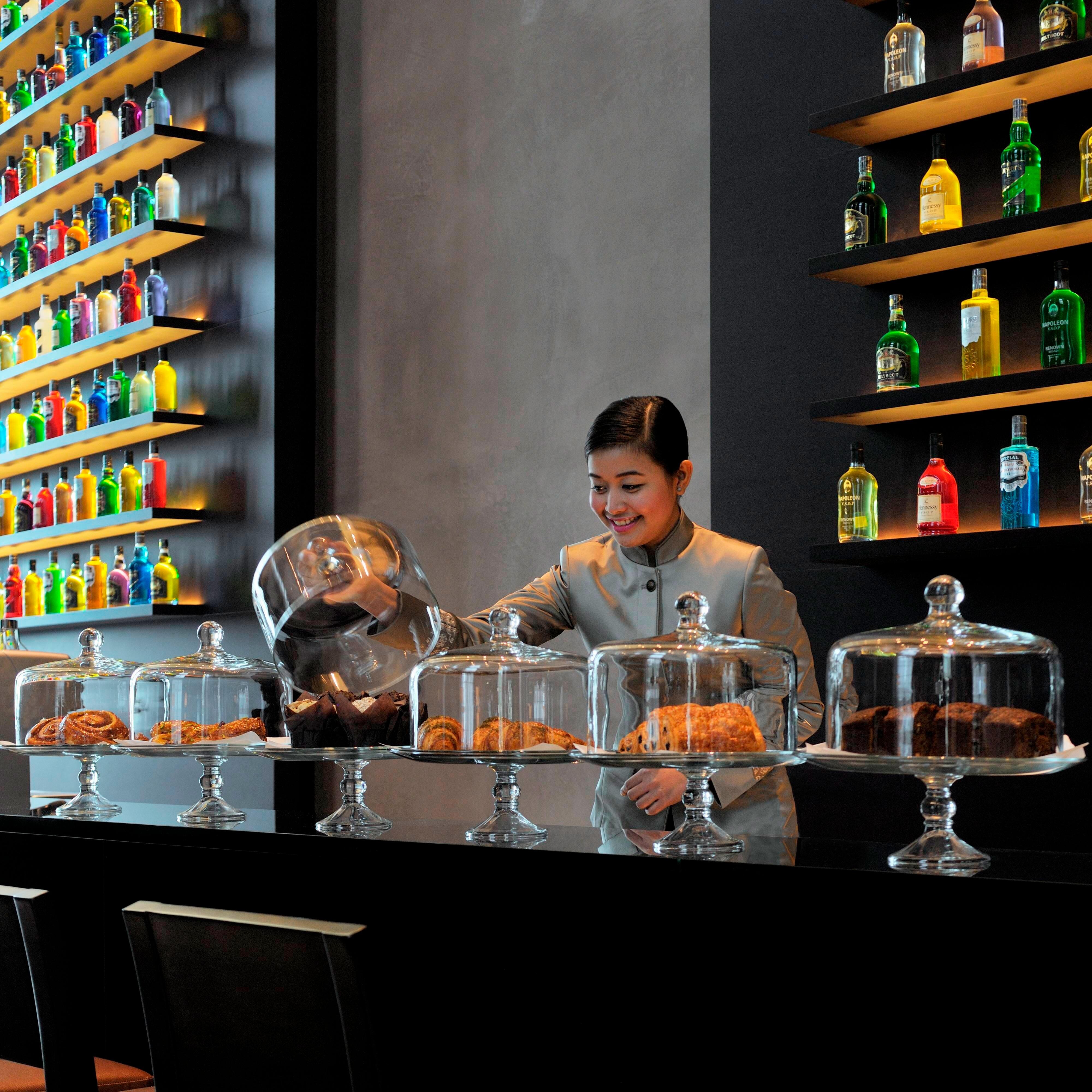 Lounge staff displaying baked goods