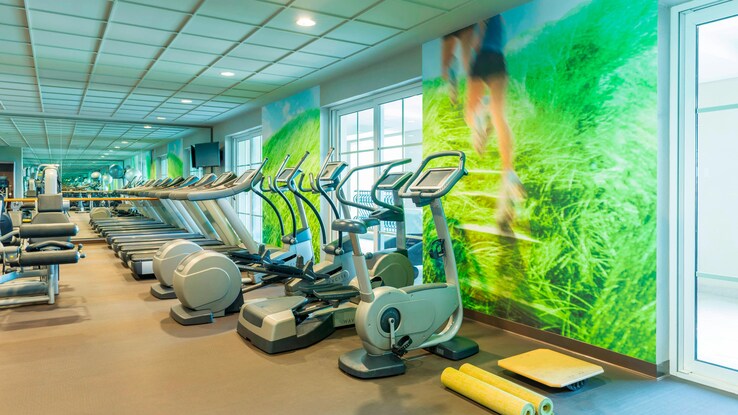 Gym with several workout equipments.