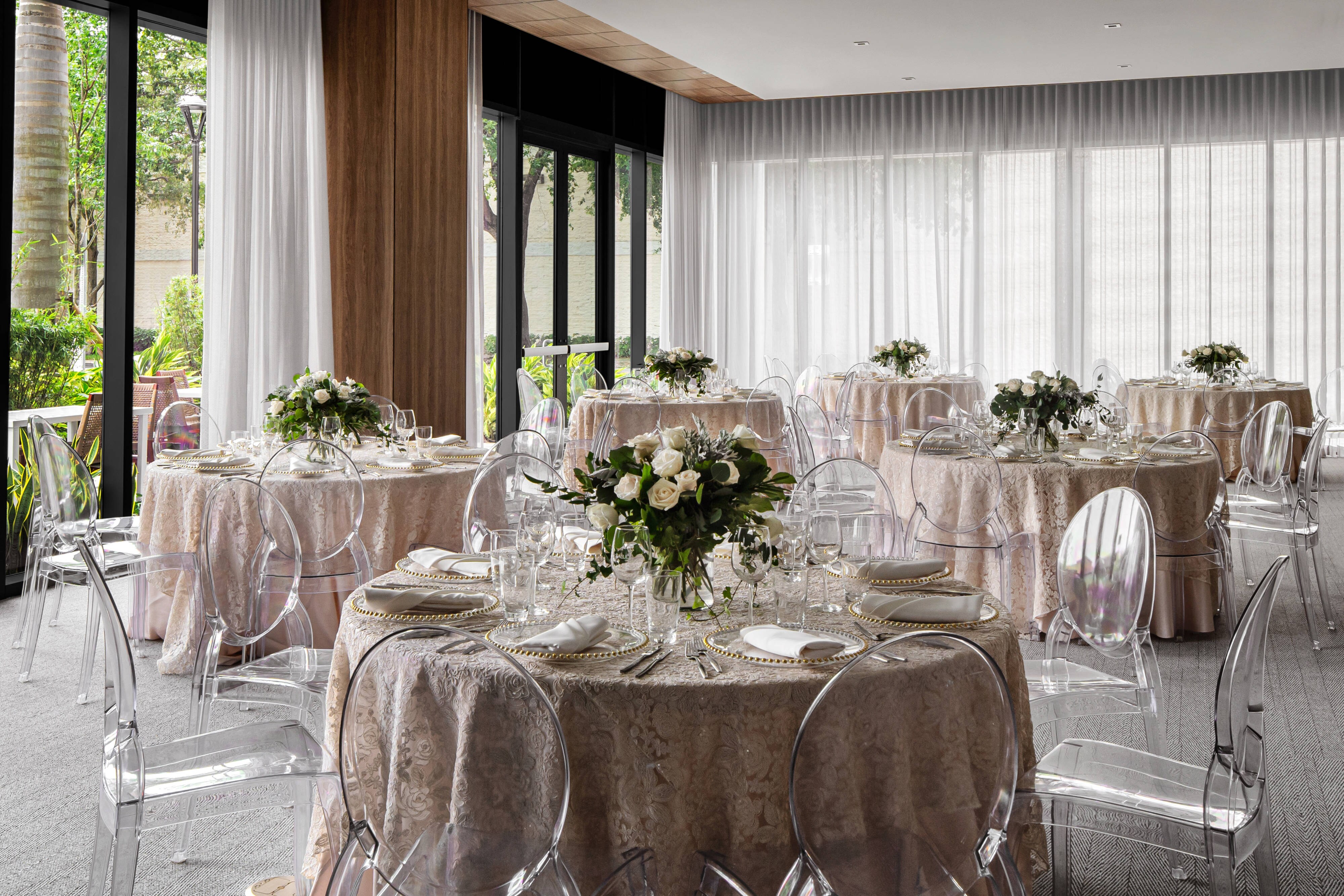 Ballroom wedding reception with floor to ceiling windows
