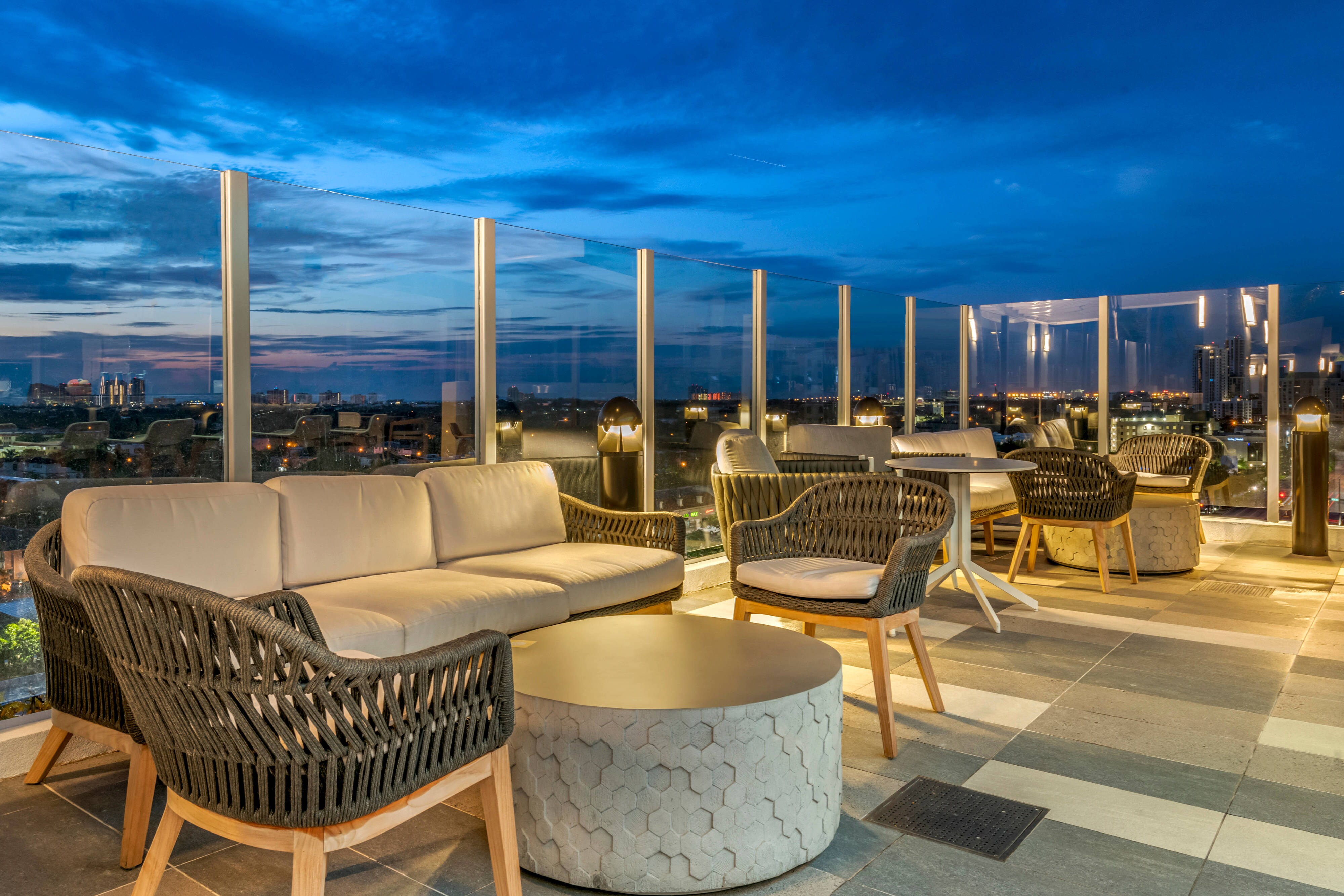 Rooftop bar couches and chairs with city view