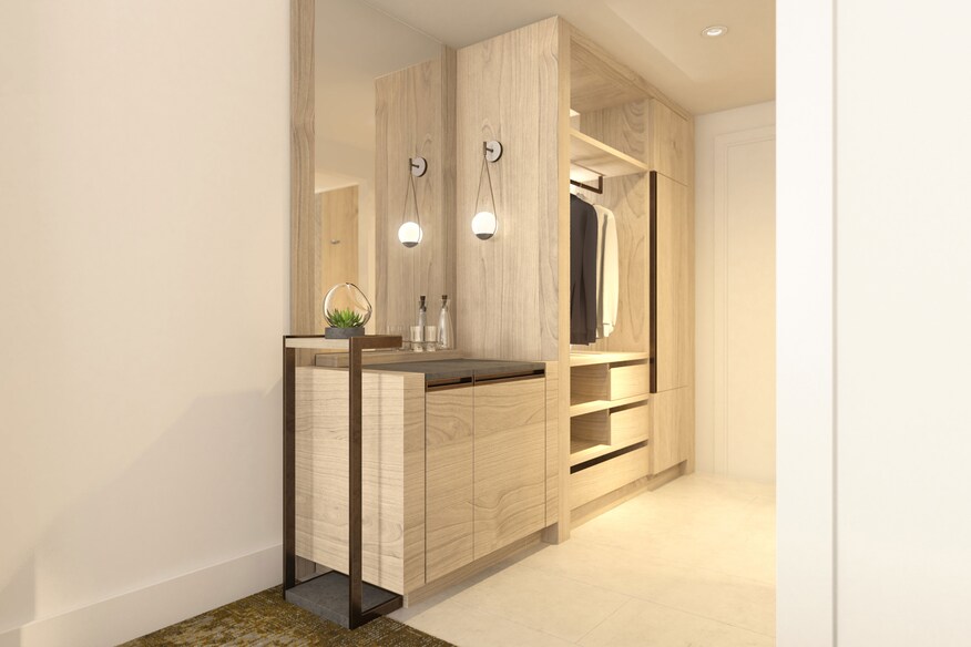 On Suite walk in closet with jackets hanging up.