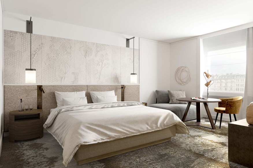 Room with large bed and table and chairs next to window.
