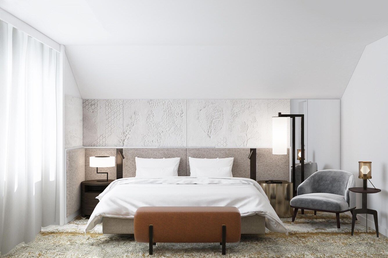 Presidential suite bed next to bright window.