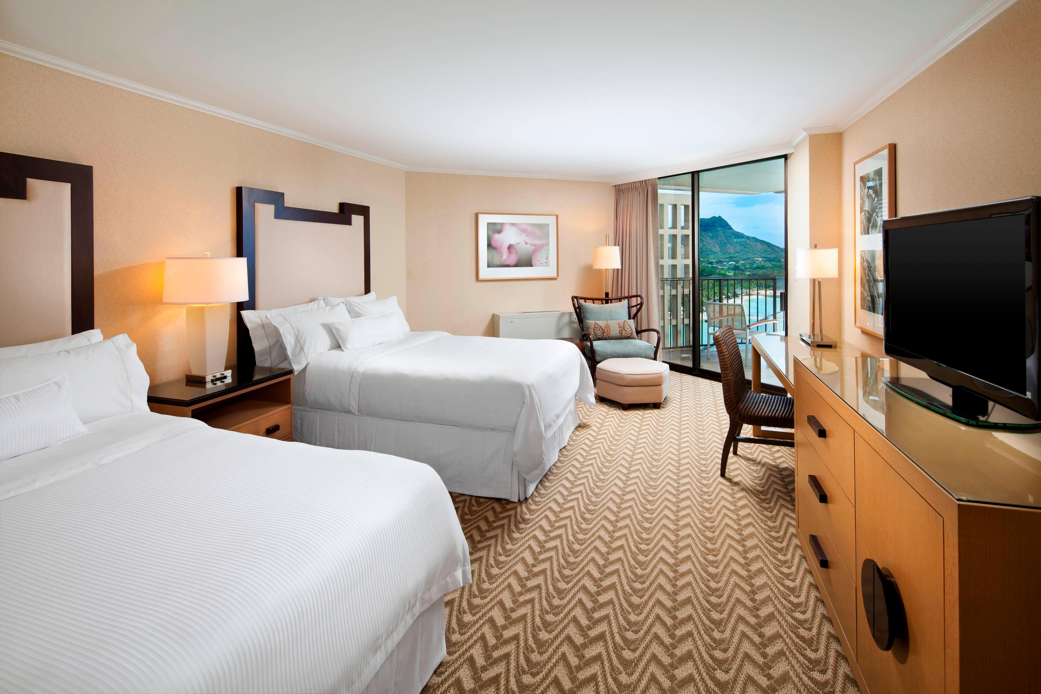 Guest room with two beds and ocean views