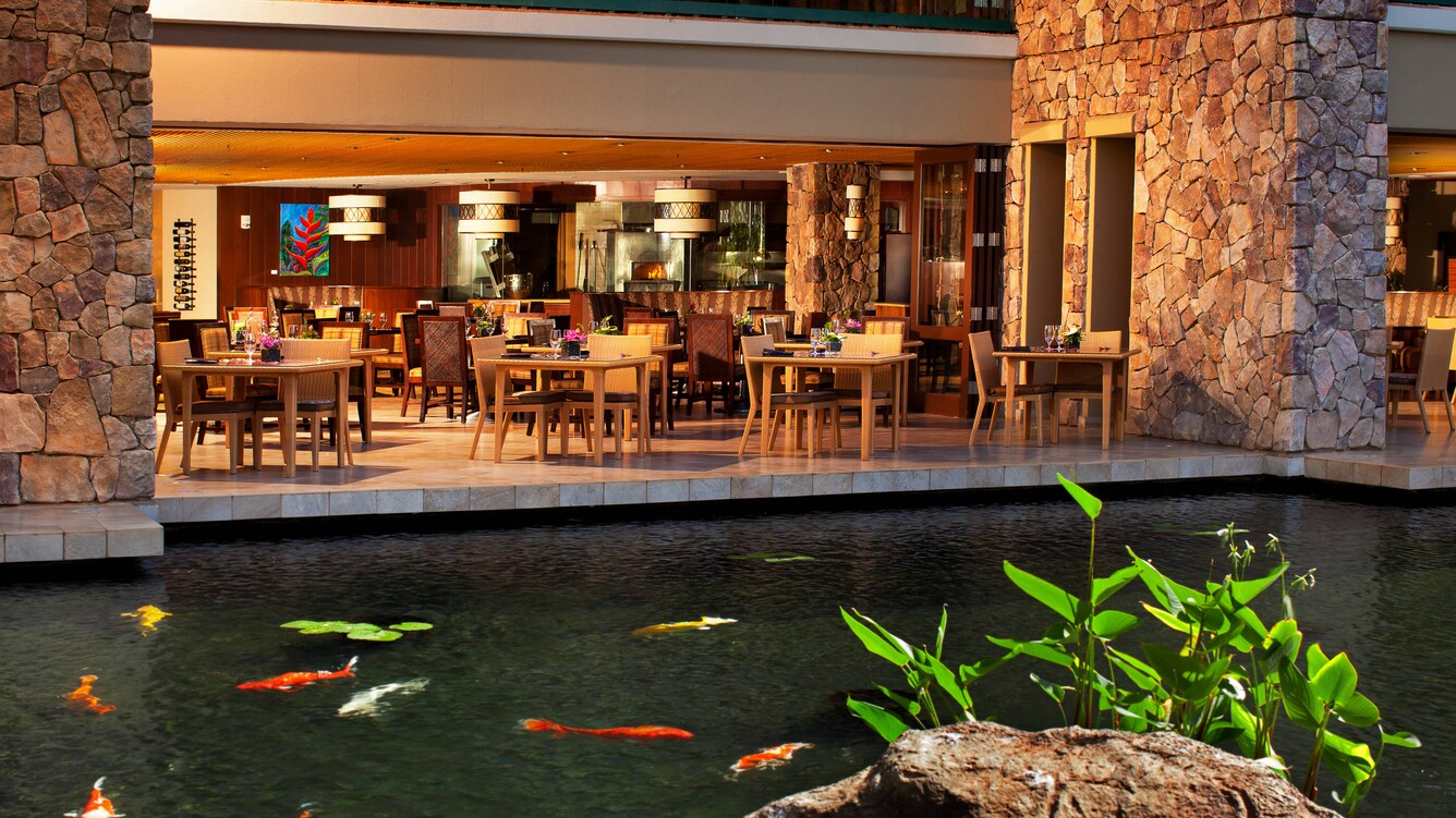 Koi pond in front of outdoor restaurant patio.
