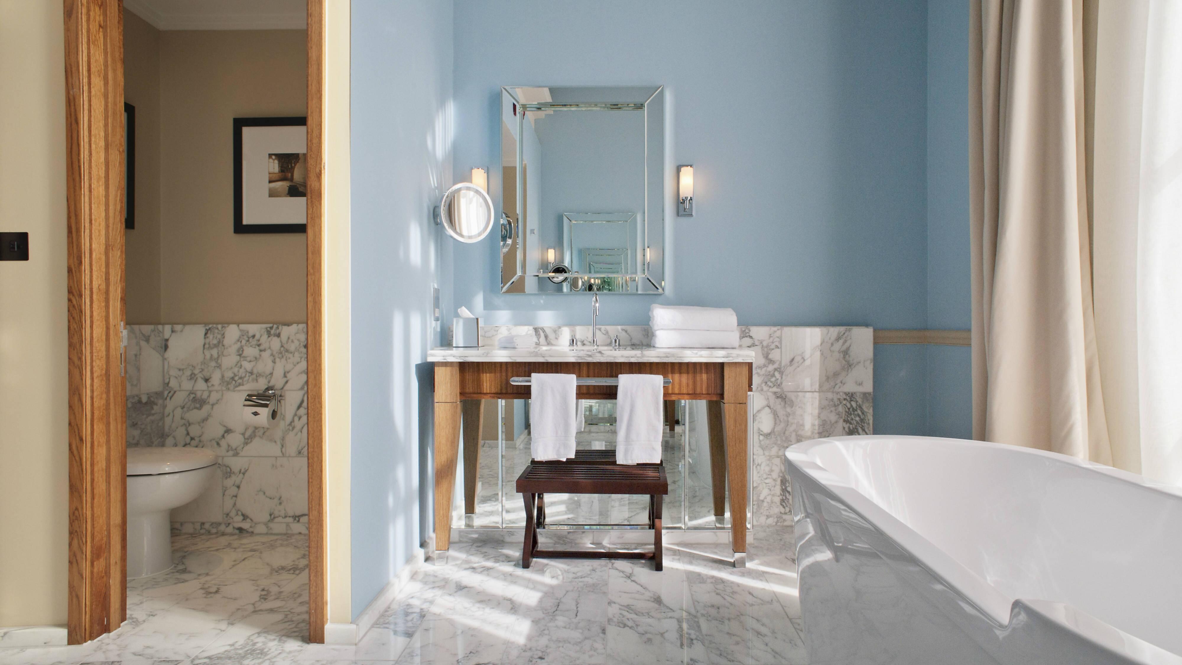 Bathroom with tub and granite floors