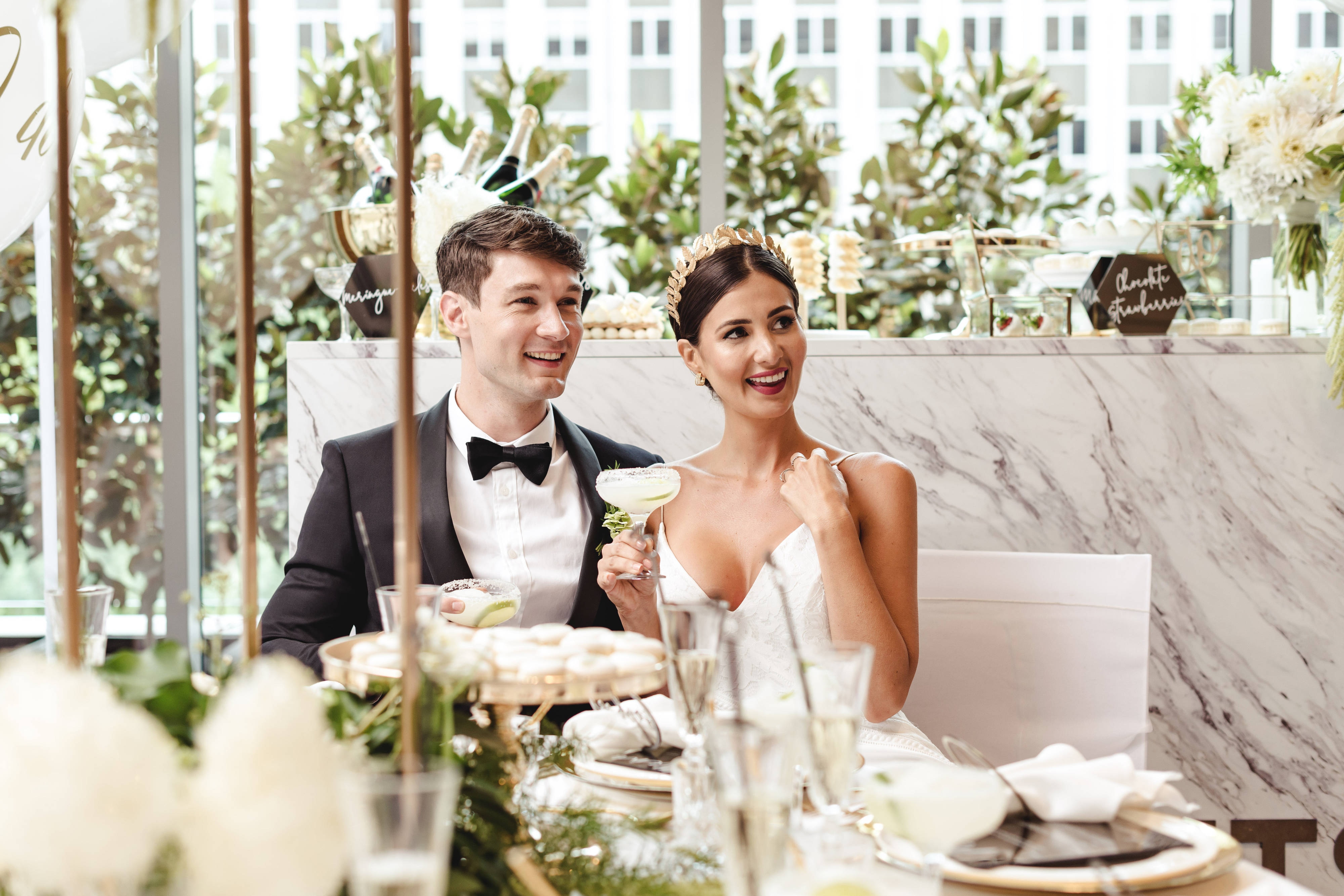 Bride and groom sitting at reception table