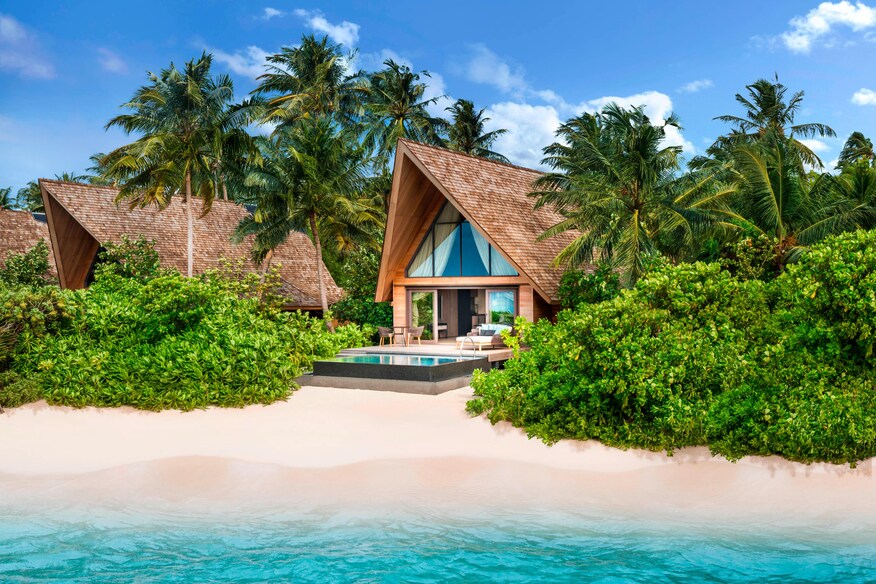 Small villa and pool on beach.