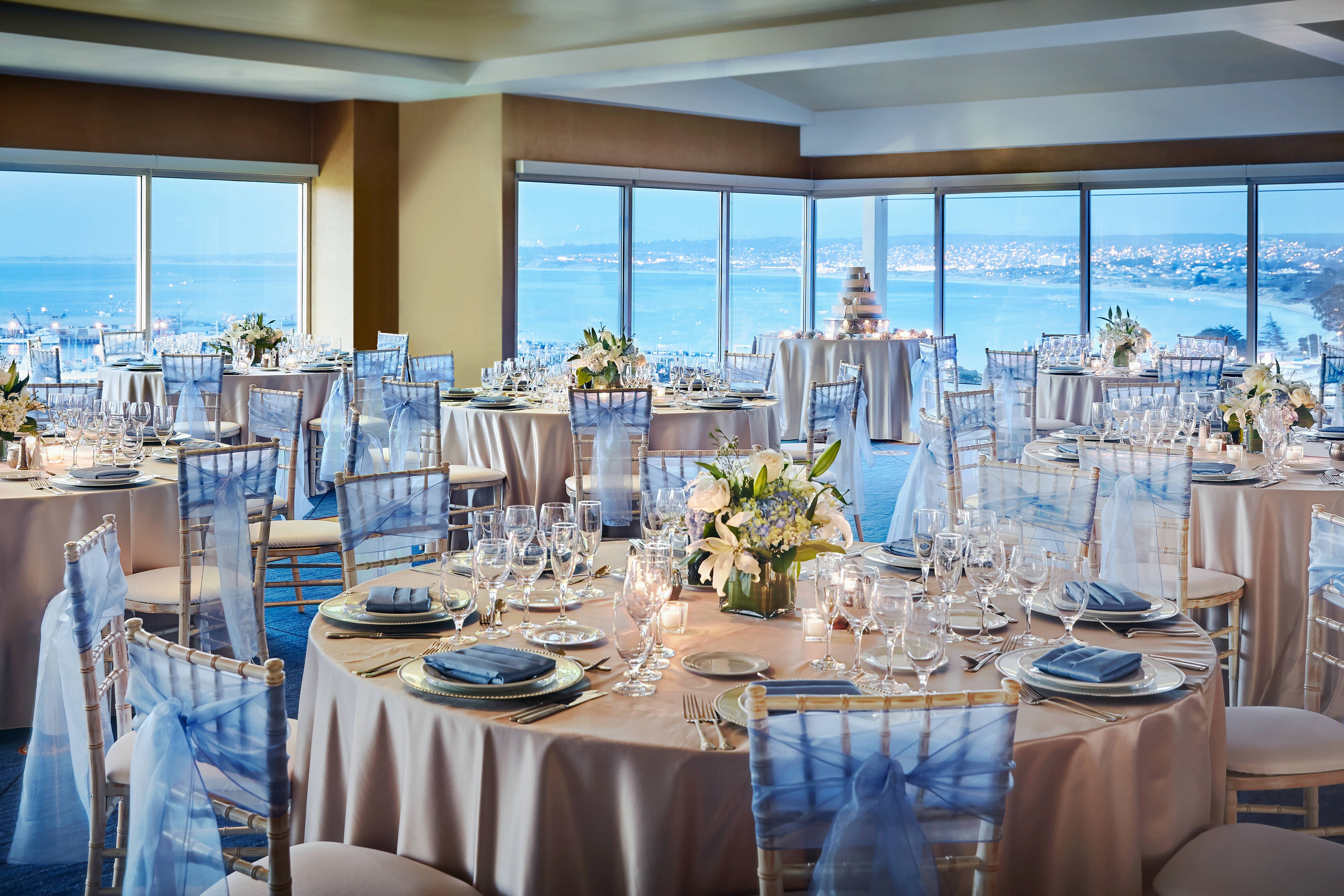 Ballroom event tables with windows and ocean view