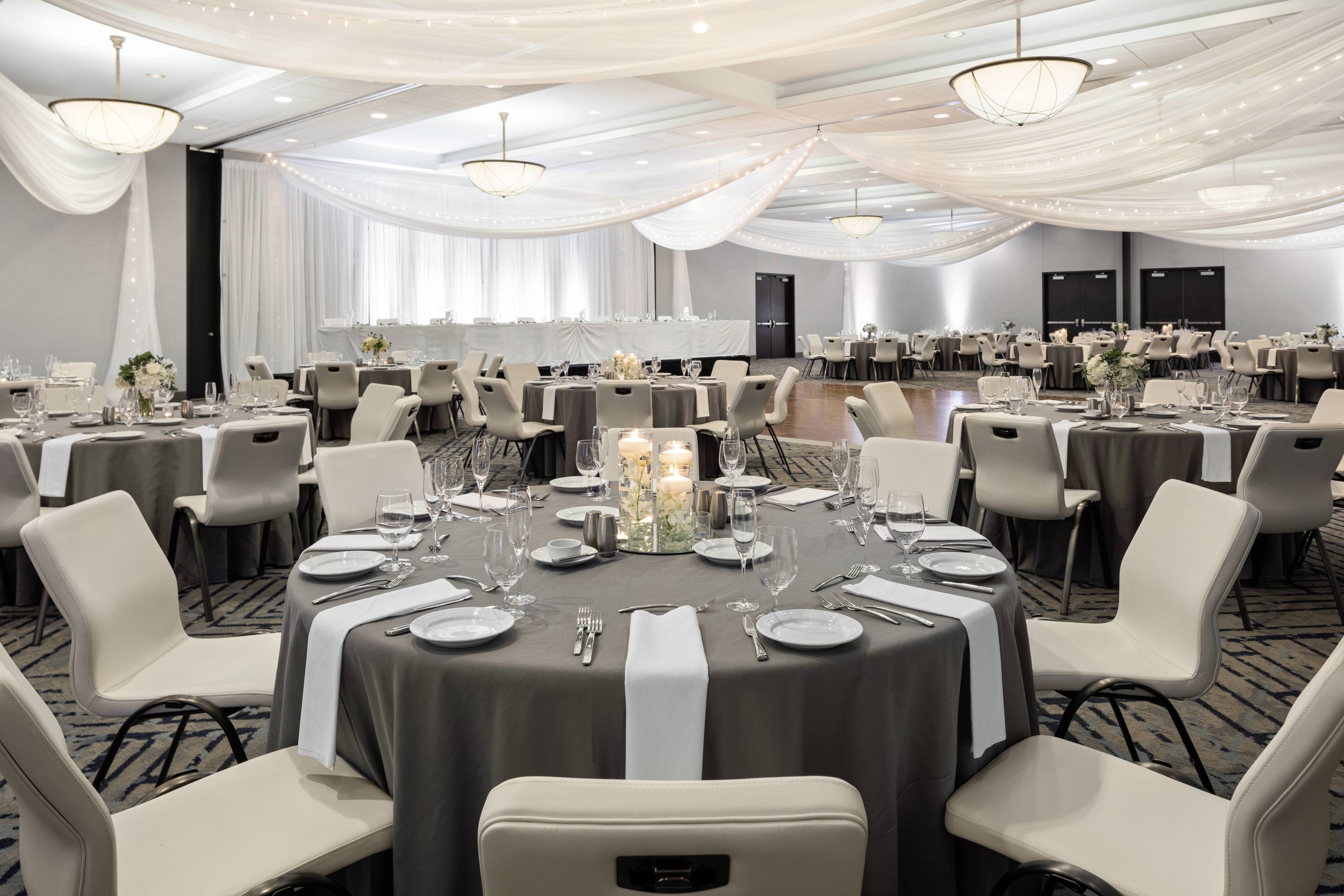 Ballroom with soft white lighting and reception tables