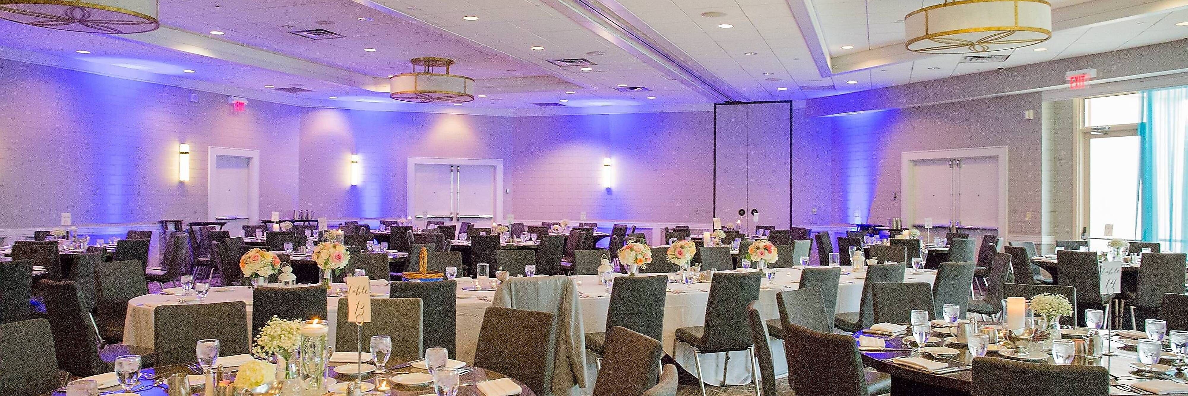 Ballroom wedding reception setup with blue accent lighting