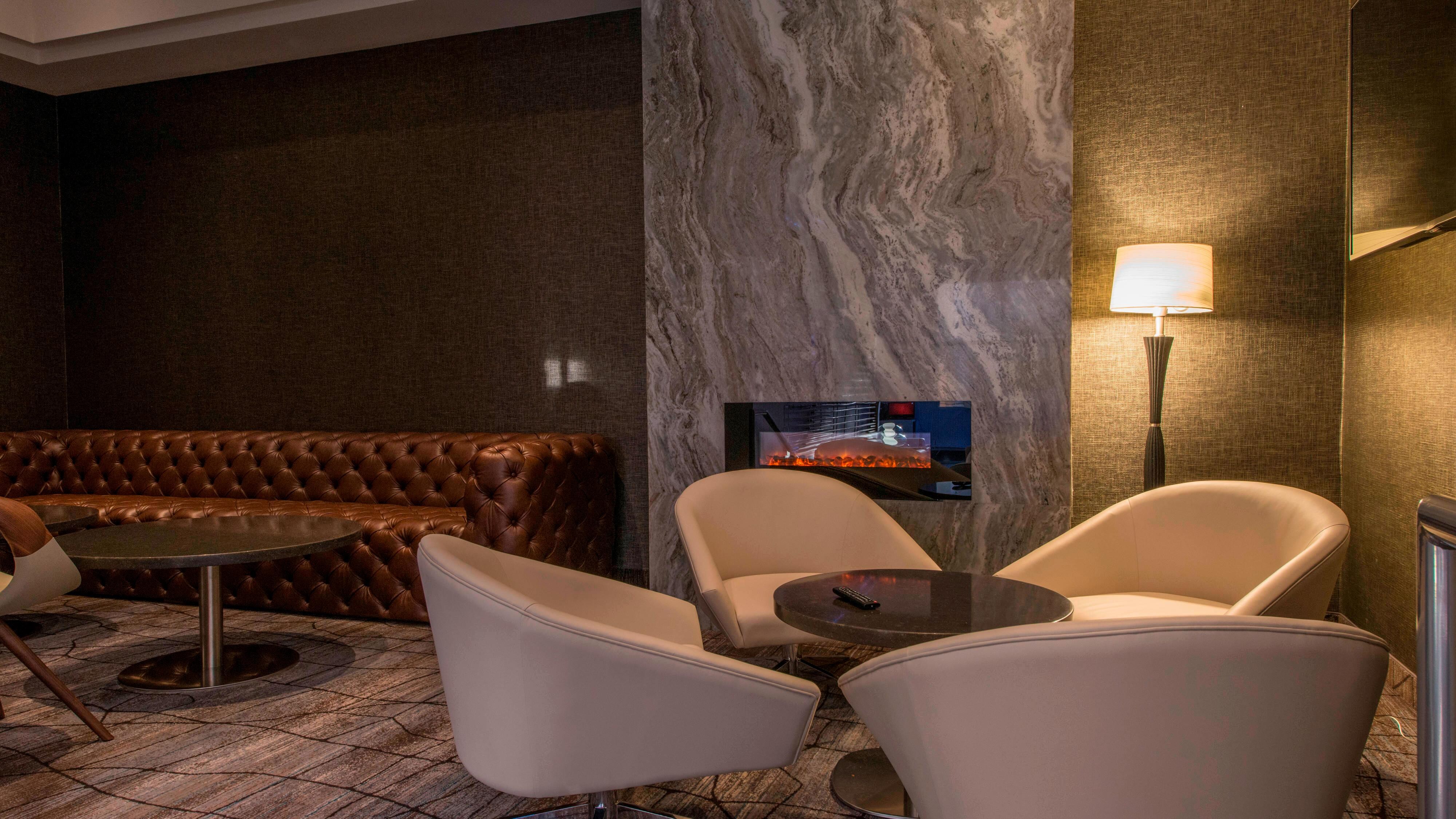 Lounge seating beside a fireplace