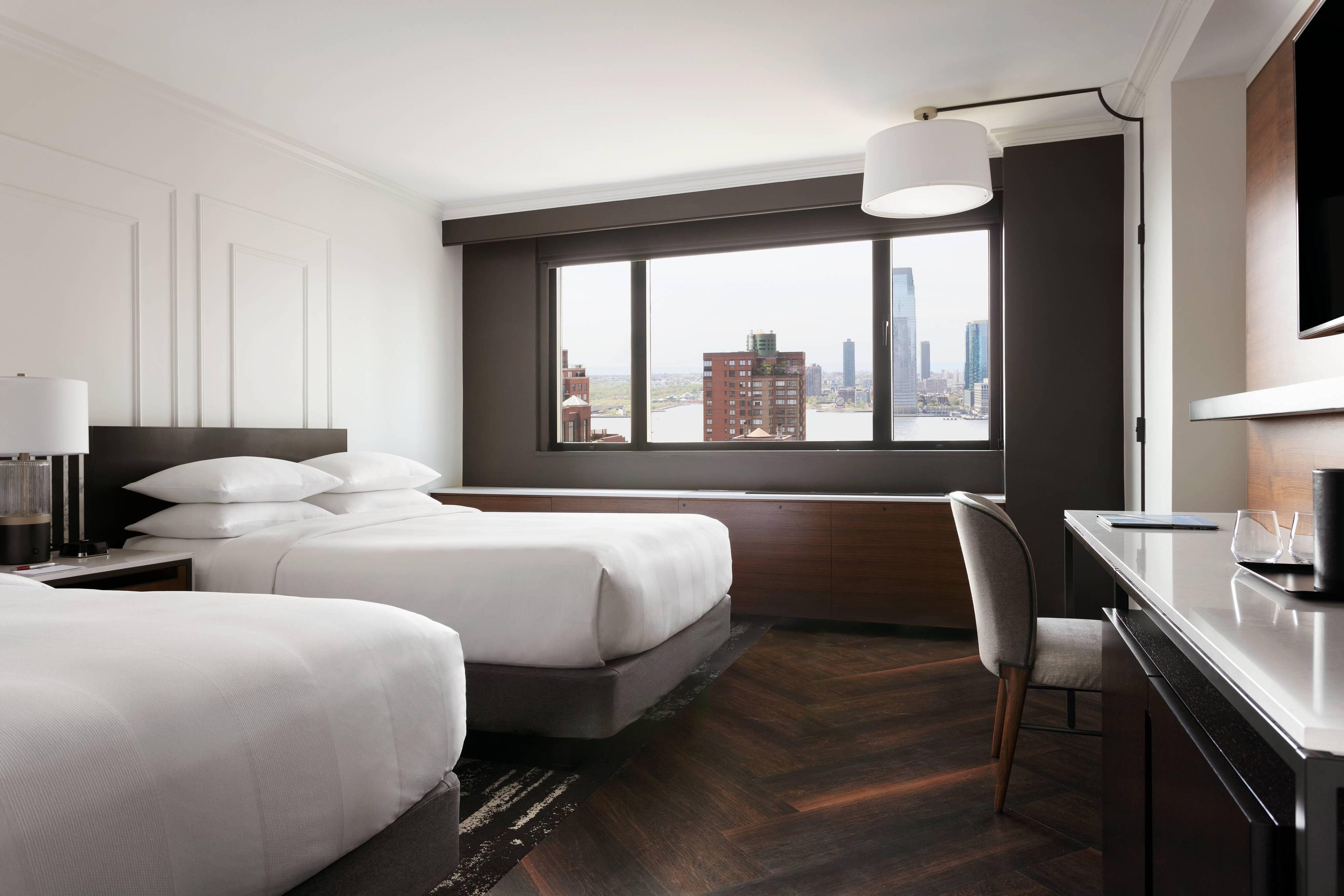 Guest room with two beds and exterior view