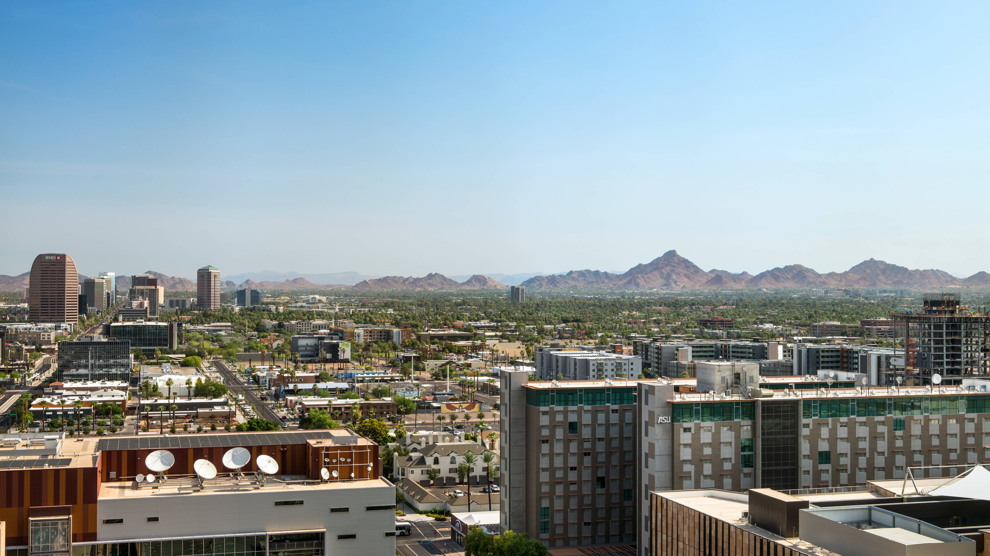 Daytime city view with mountains and buildings