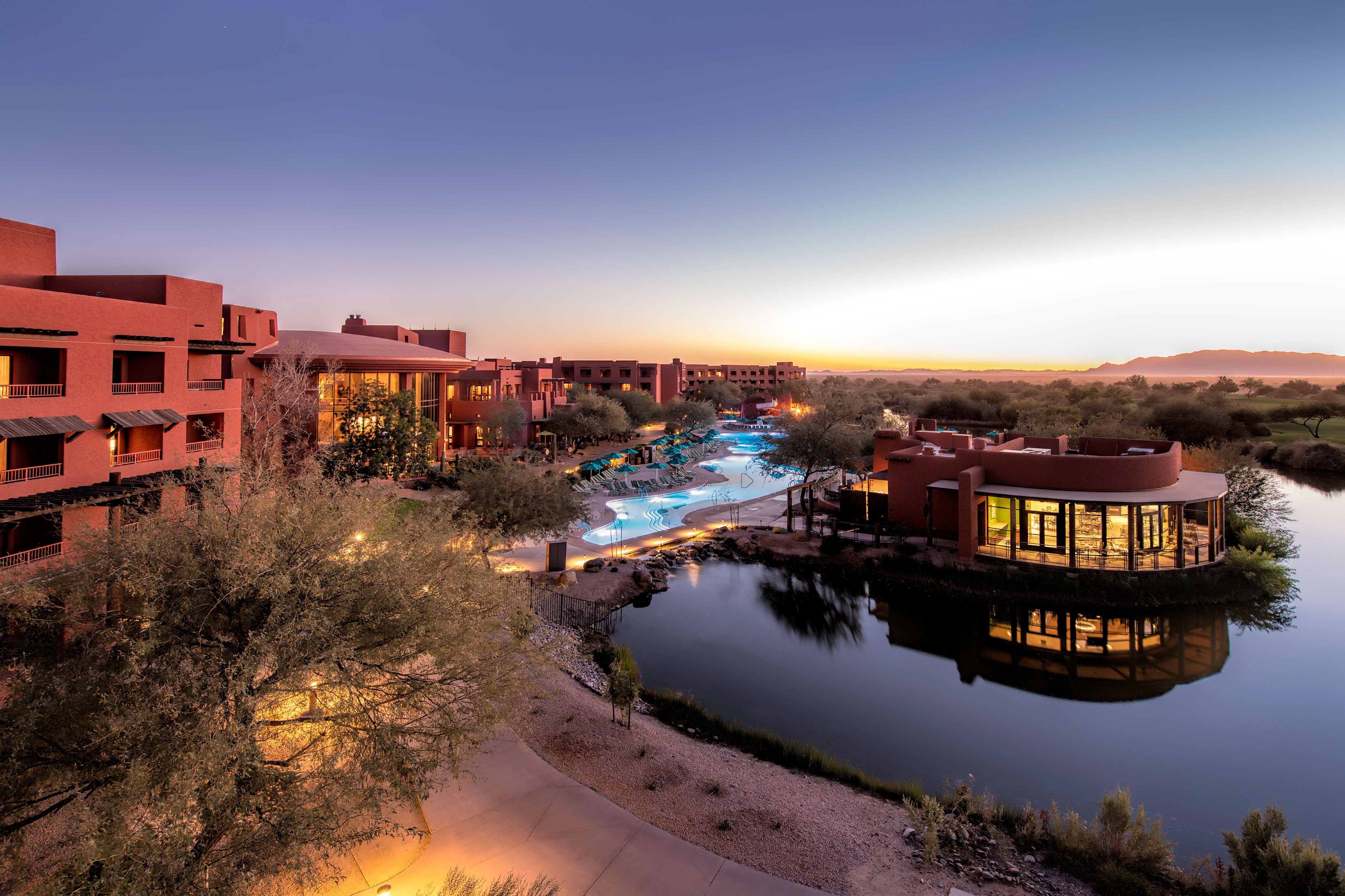 Hotel exterior. There is a large pool and a pond