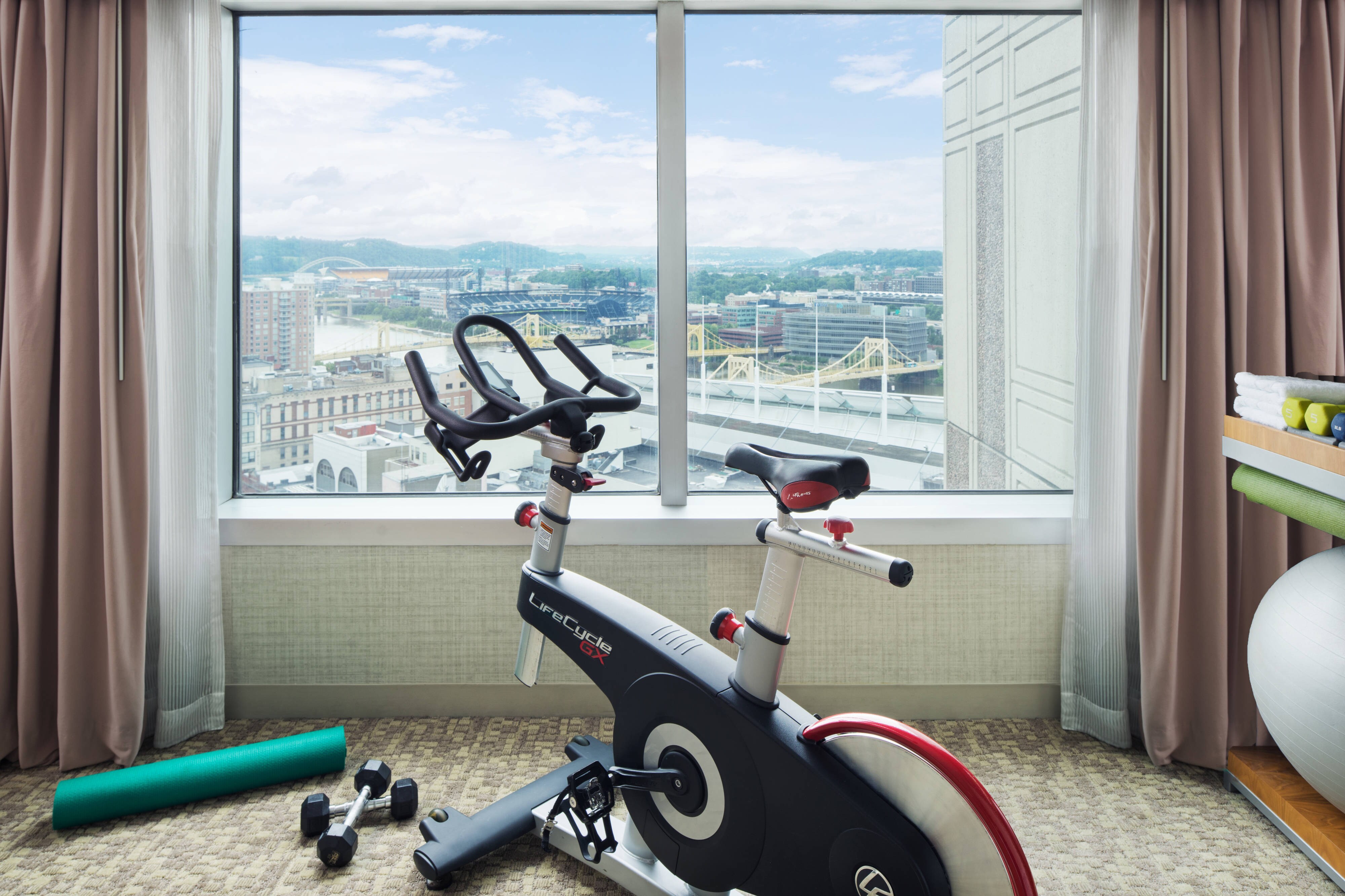 Workout bike facing window with city view