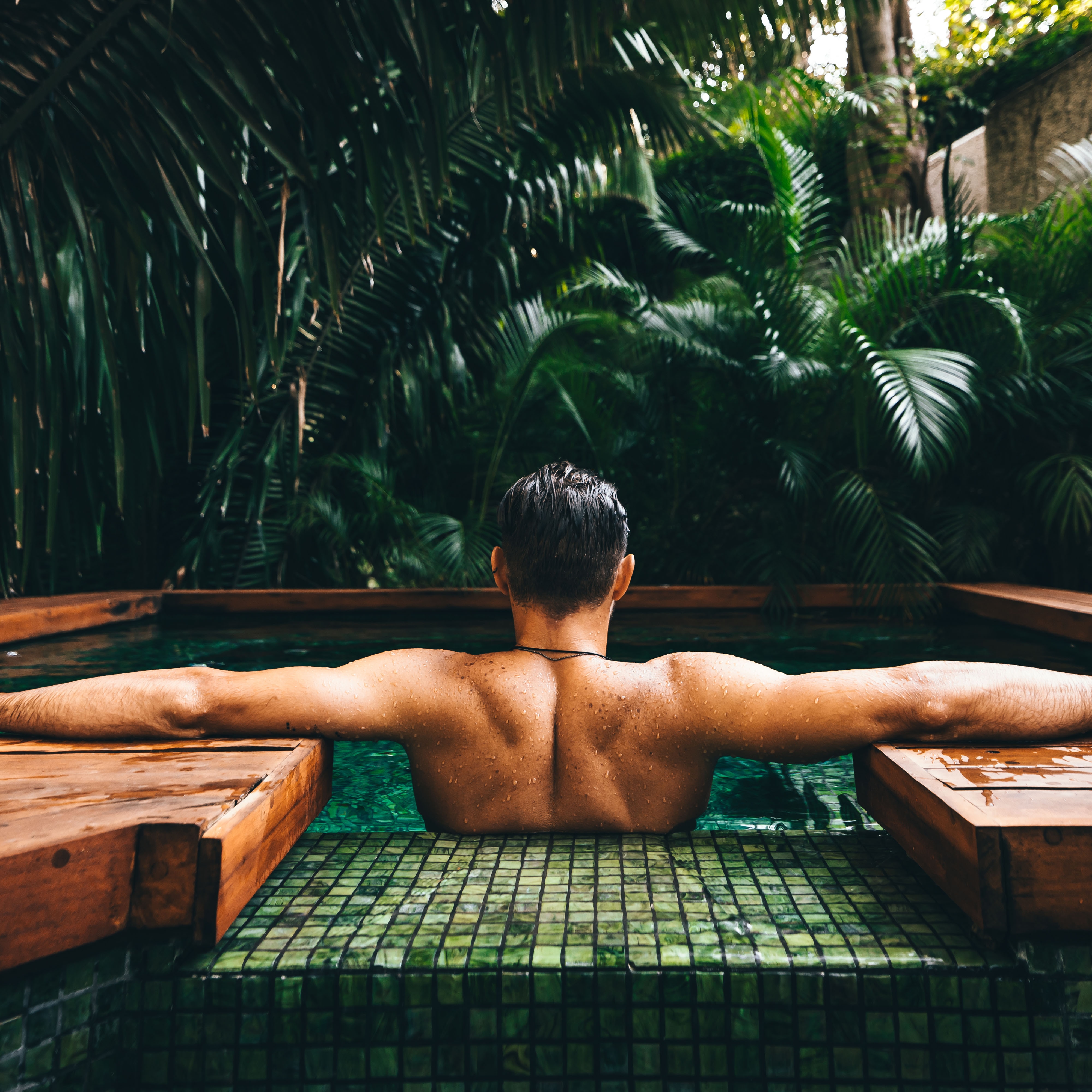 Back of man lounging in a spa