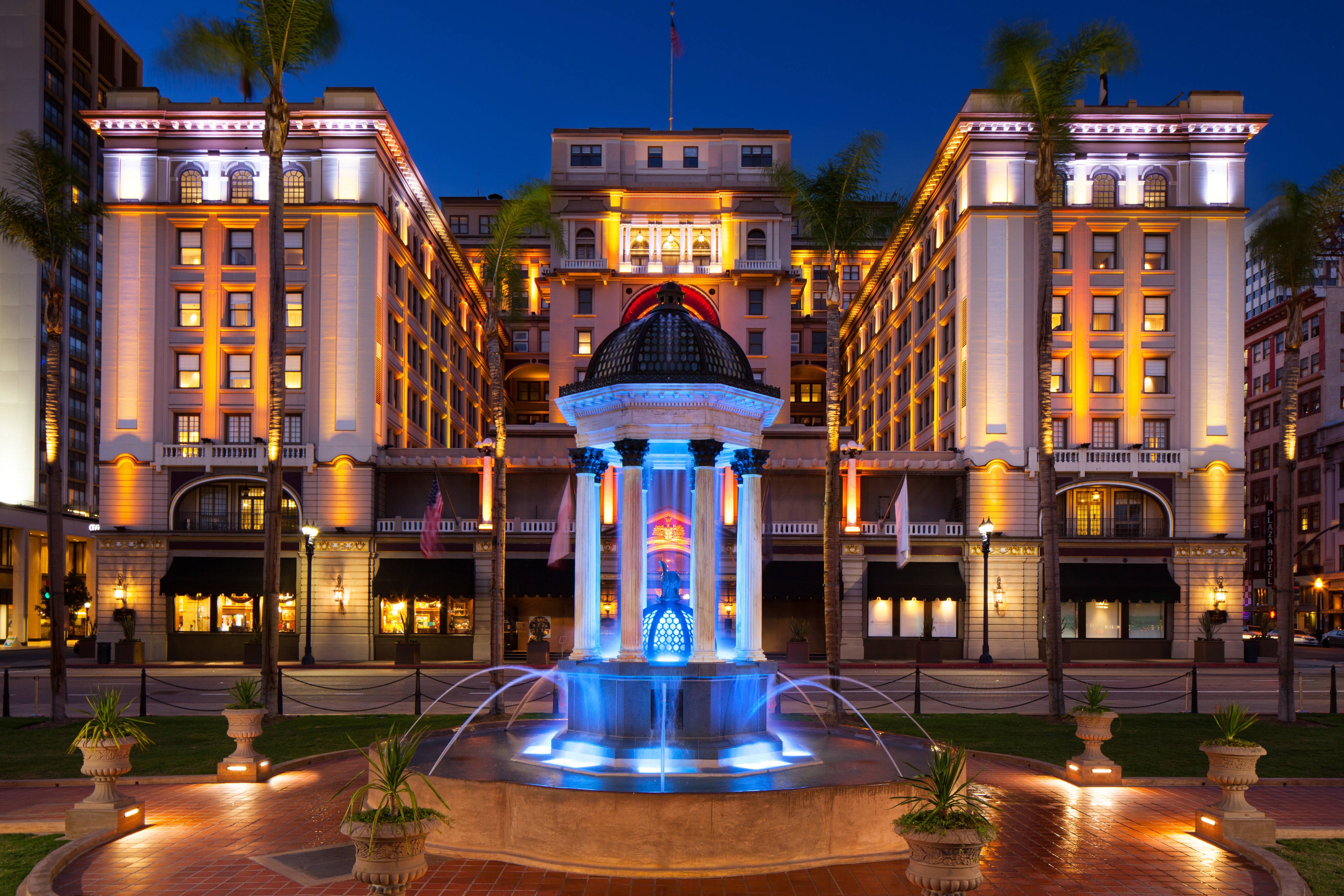 Hotel exterior and fountain lit up at night