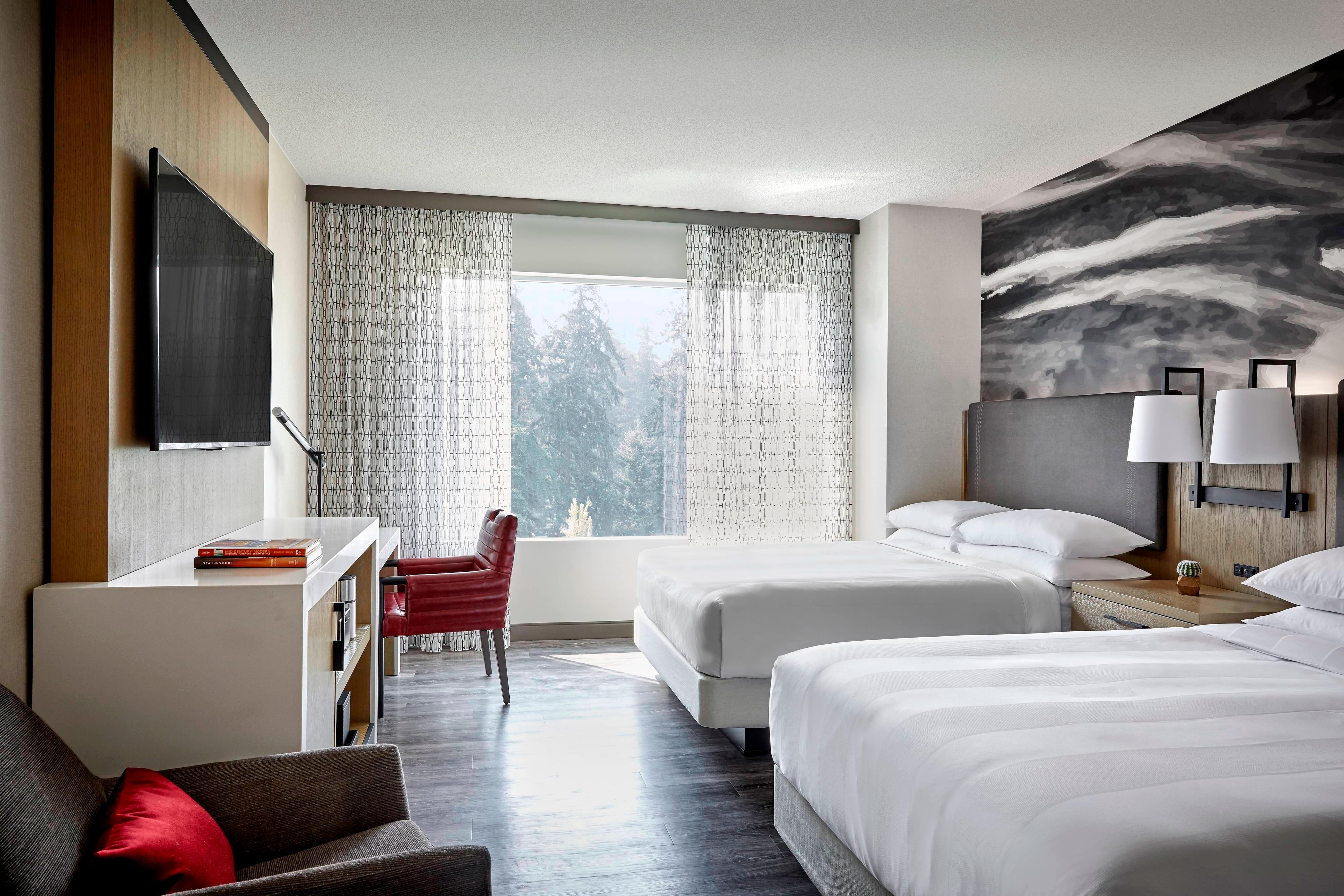 Guest room with two beds and exterior view