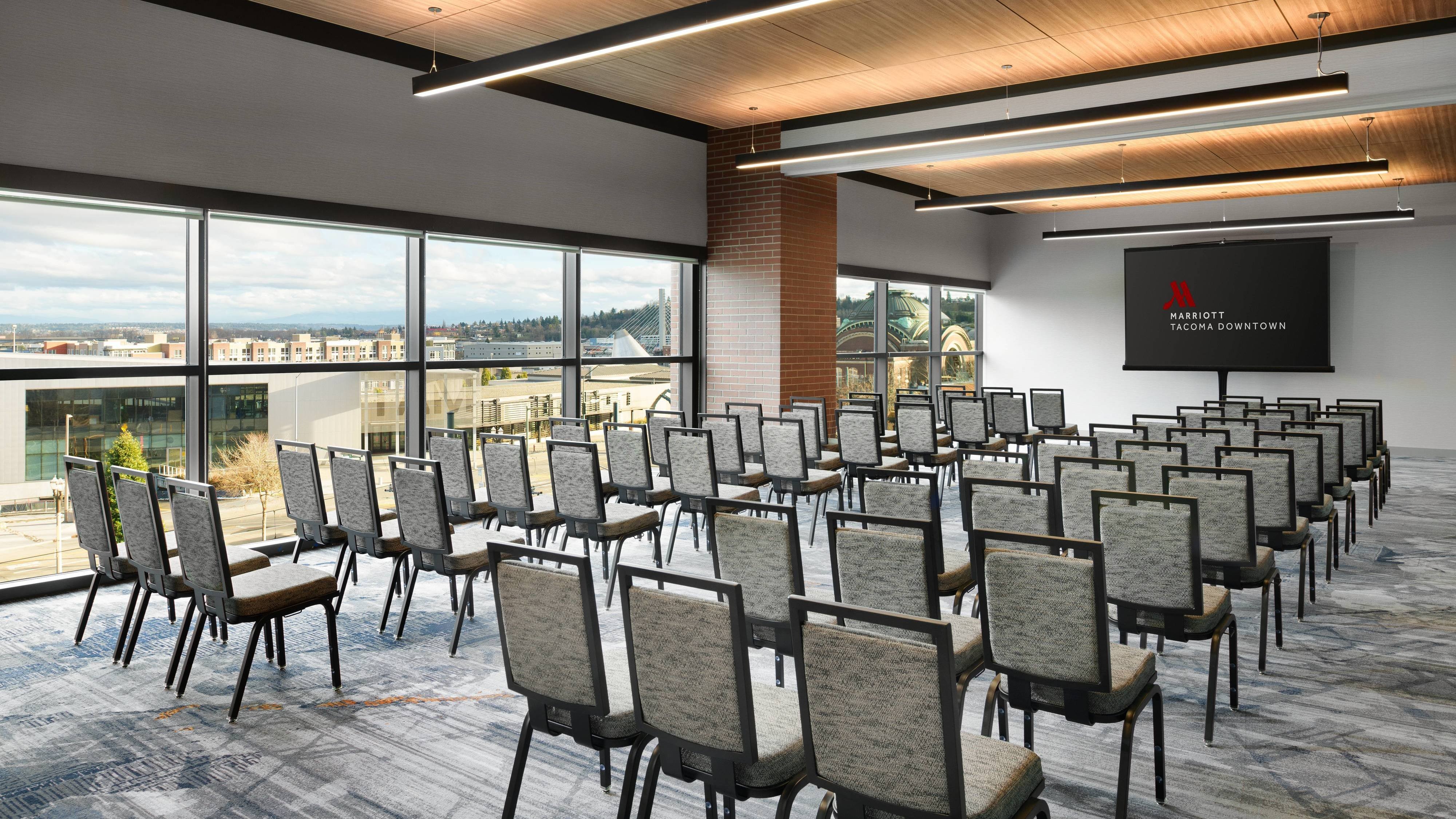 Meeting room with large windows and rows of chairs