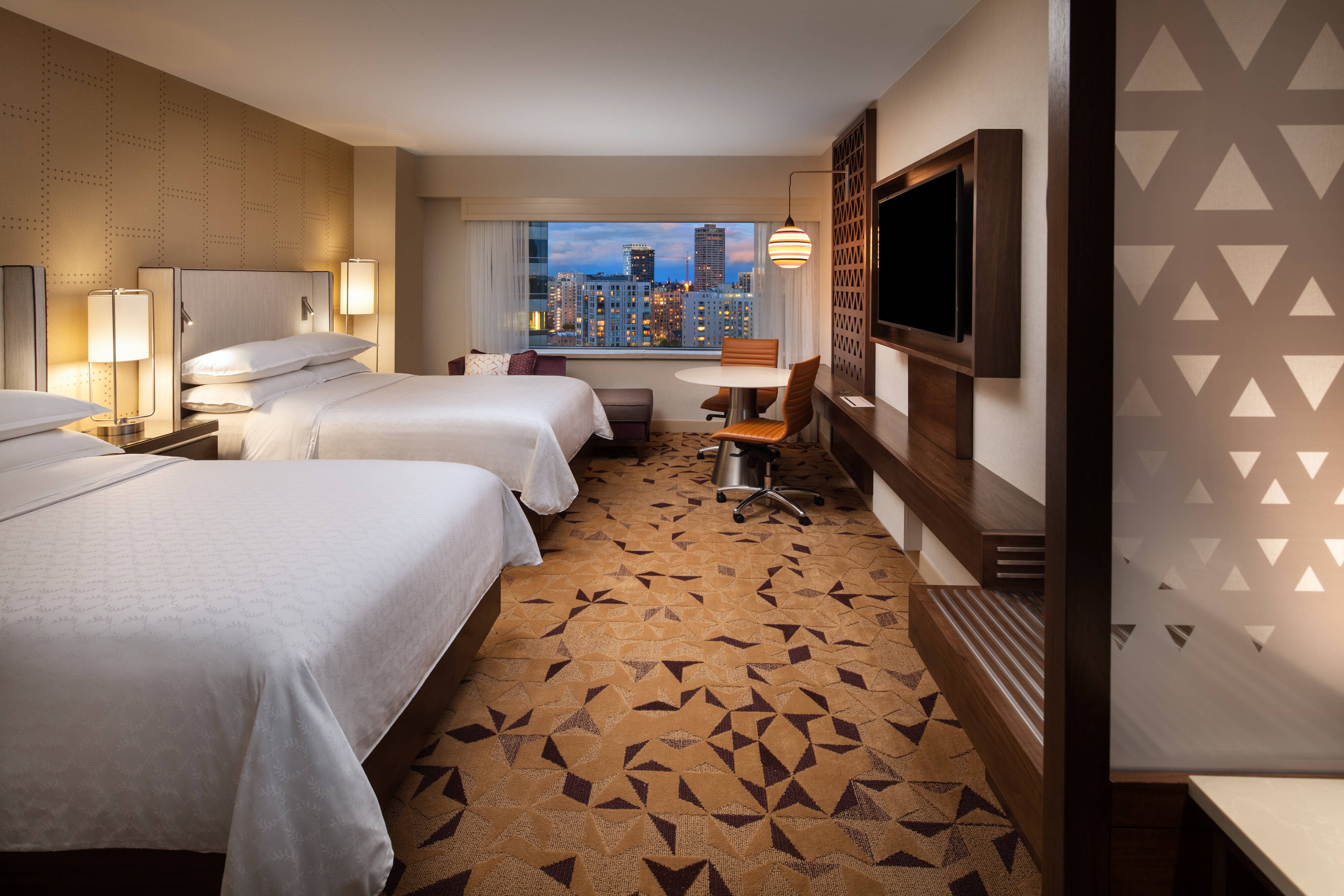 Guest room with two beds and exterior view