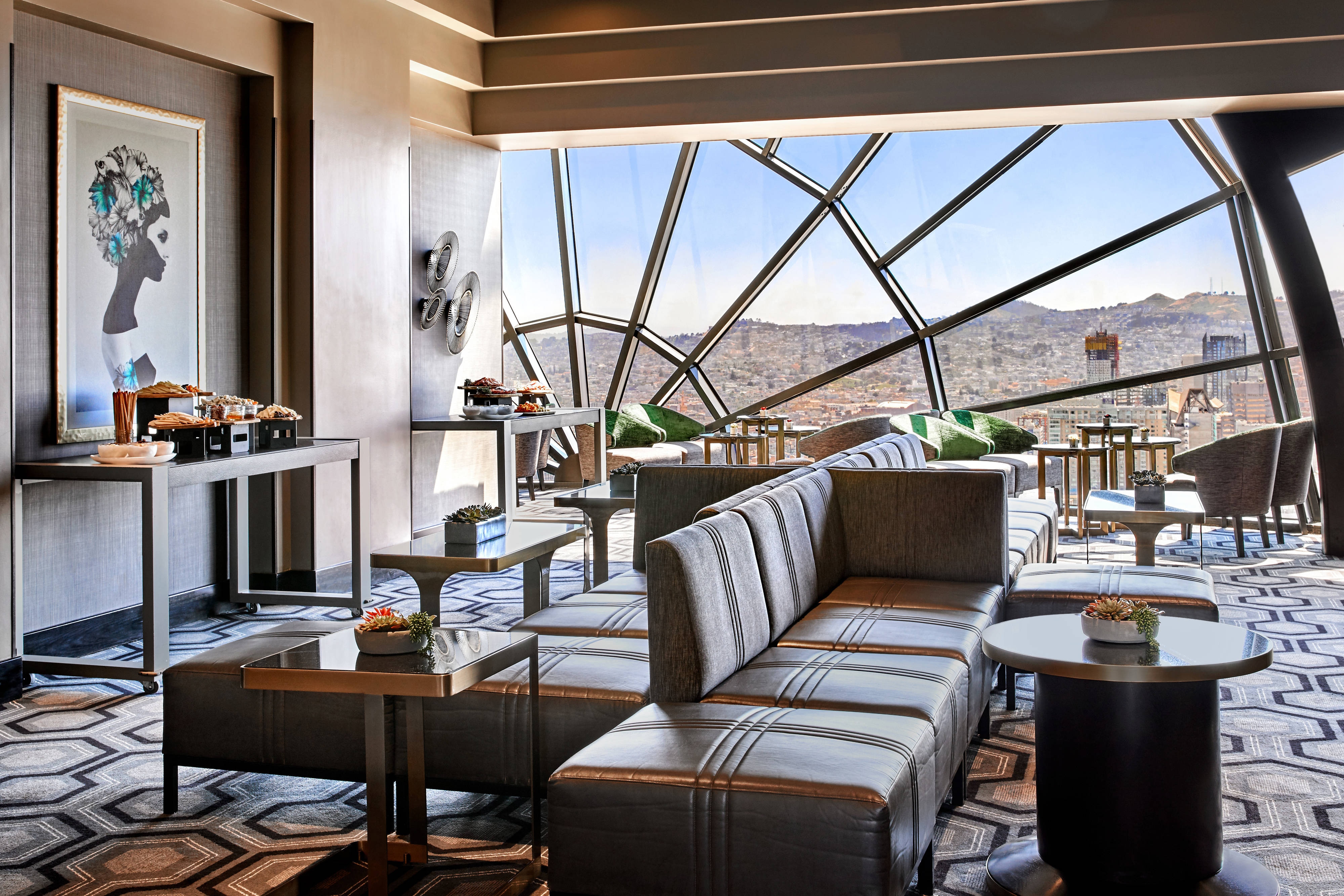 Lounge seating next to large window with city views
