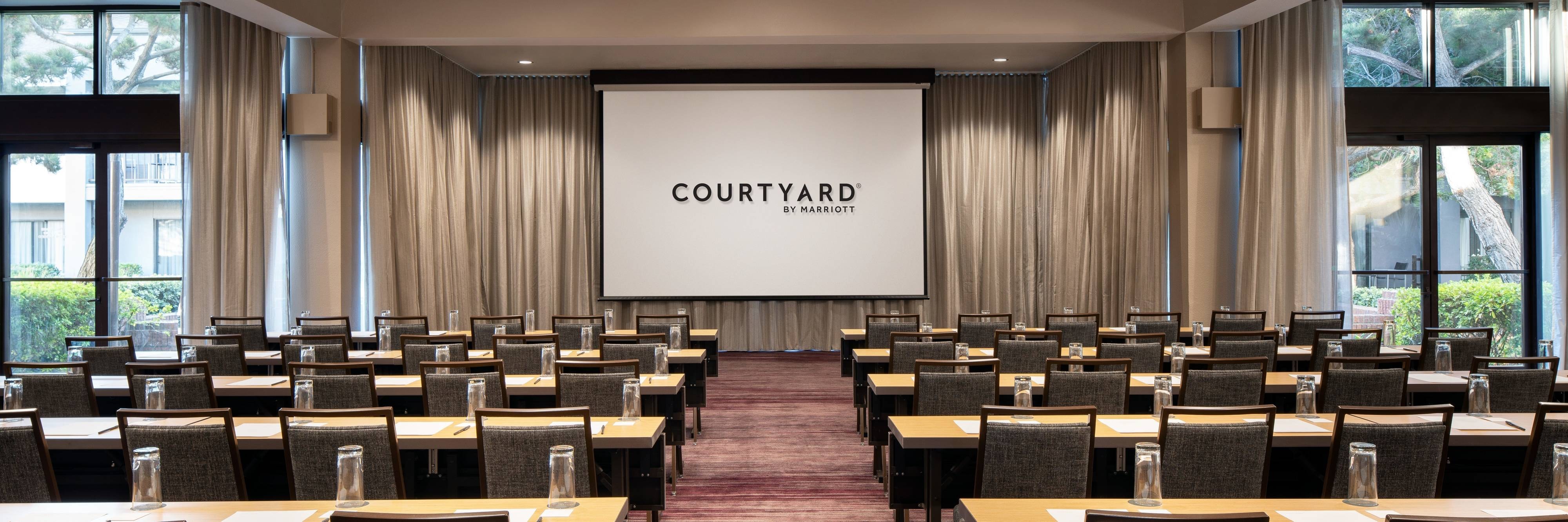 Meeting room classroom setup with projector screen