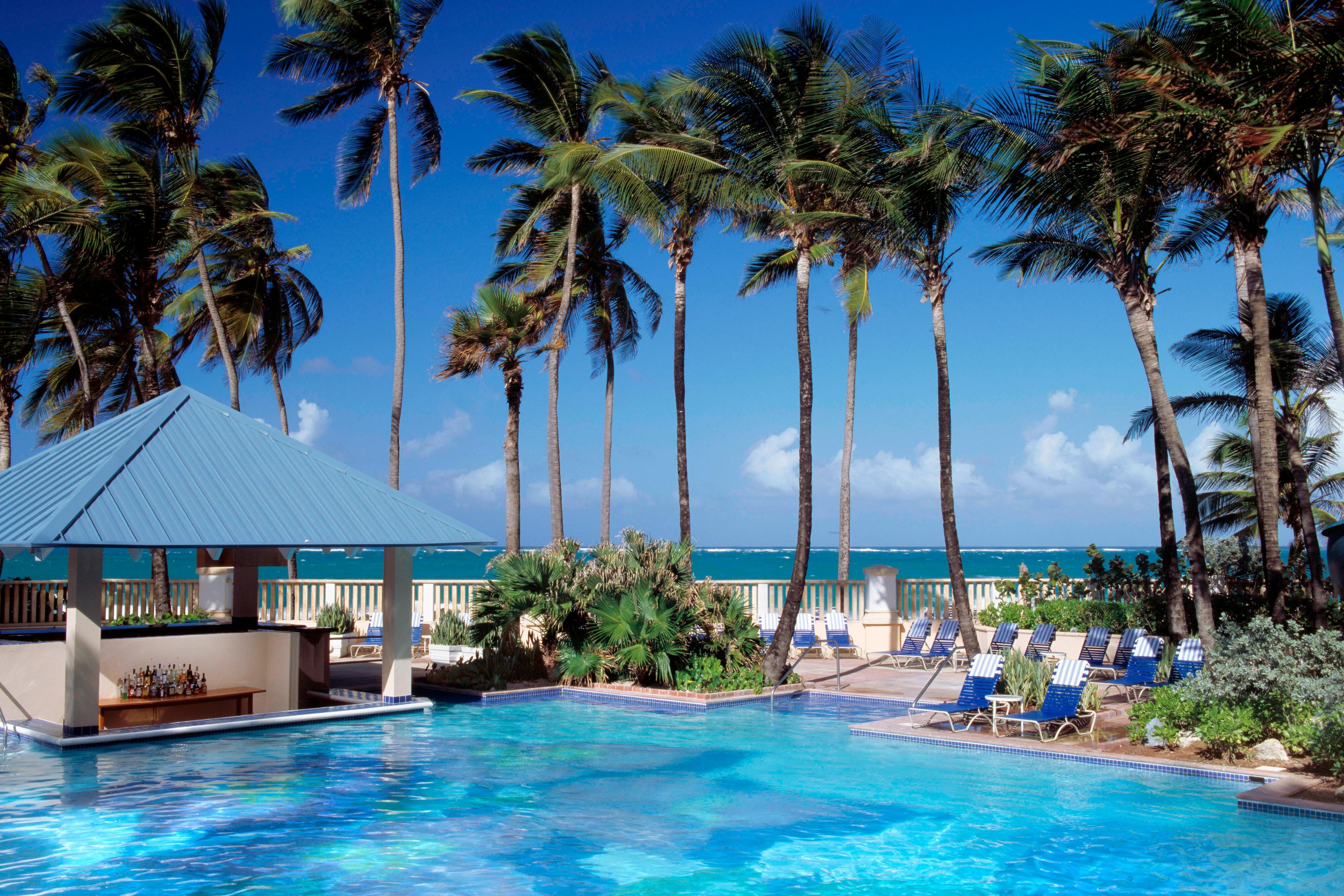 San juan marriott outdoor pool with lounge chairs and palm trees.