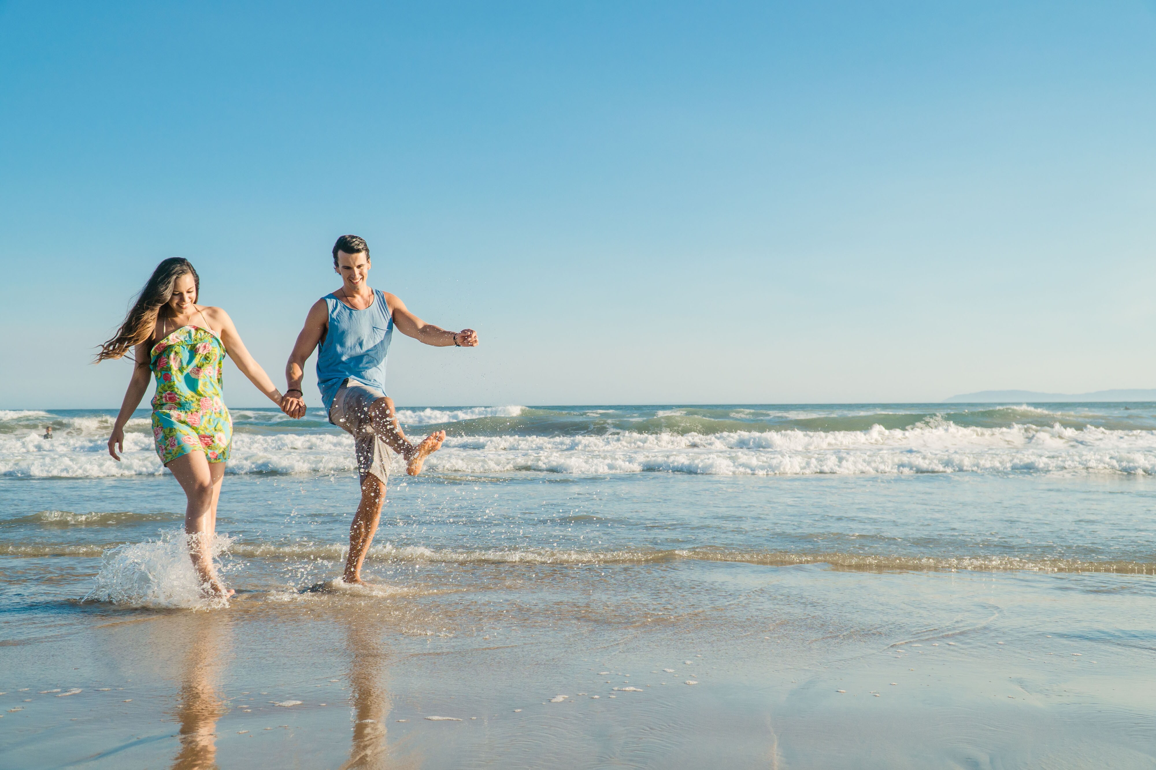 Couple holding hands on the beach