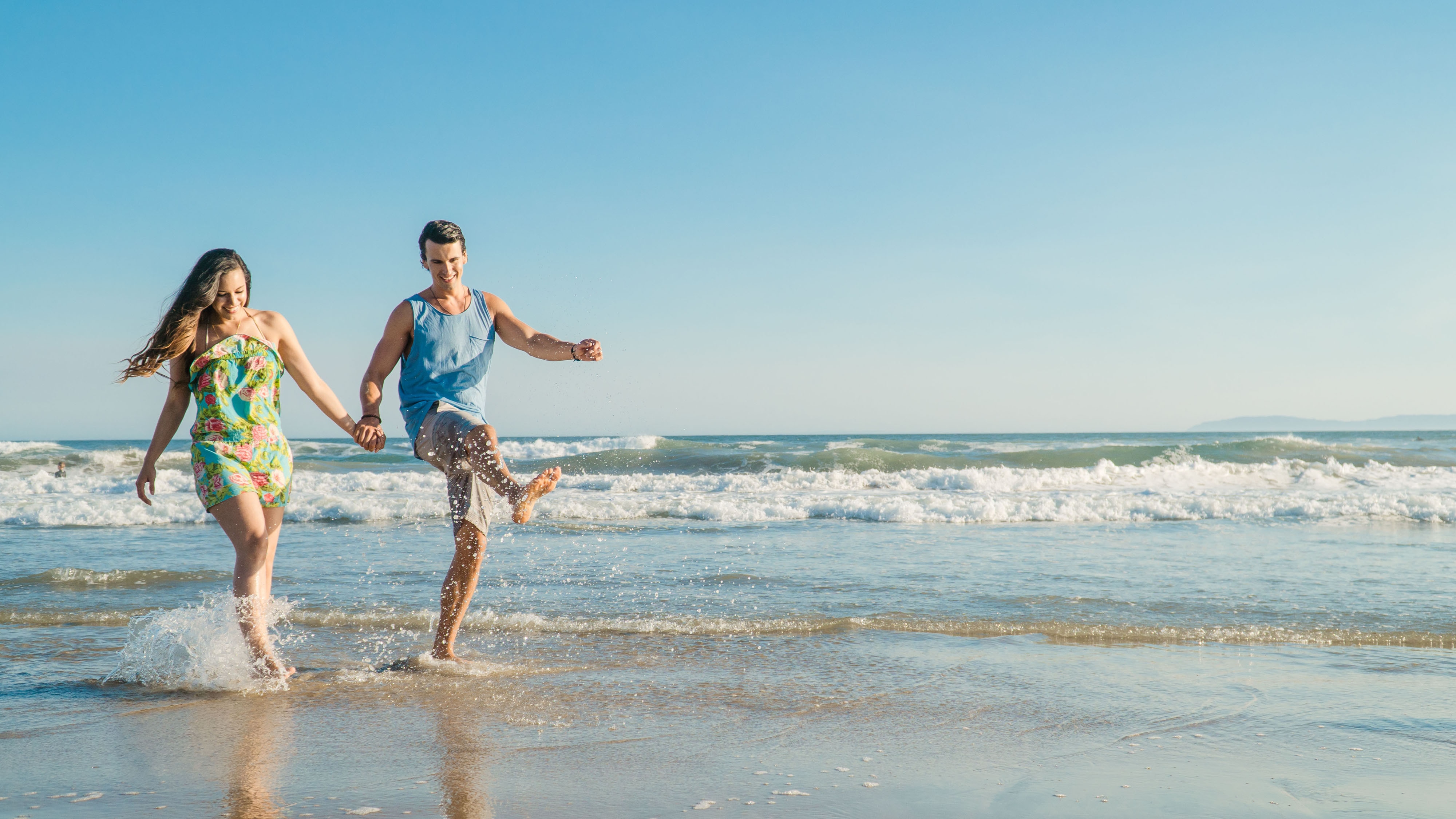 Couple holding hands on the beach