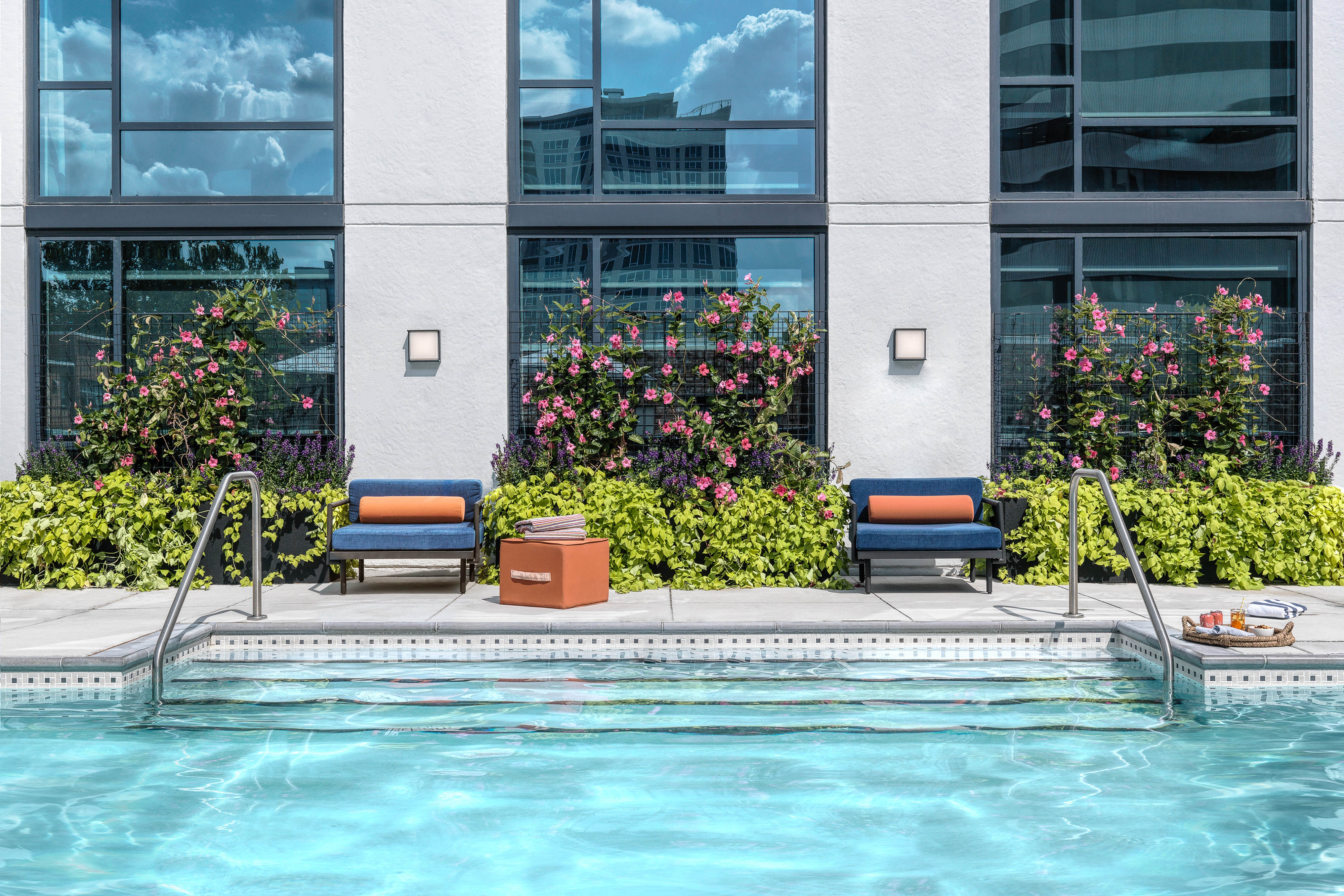 Lounge chairs beside an outdoor swimming pool