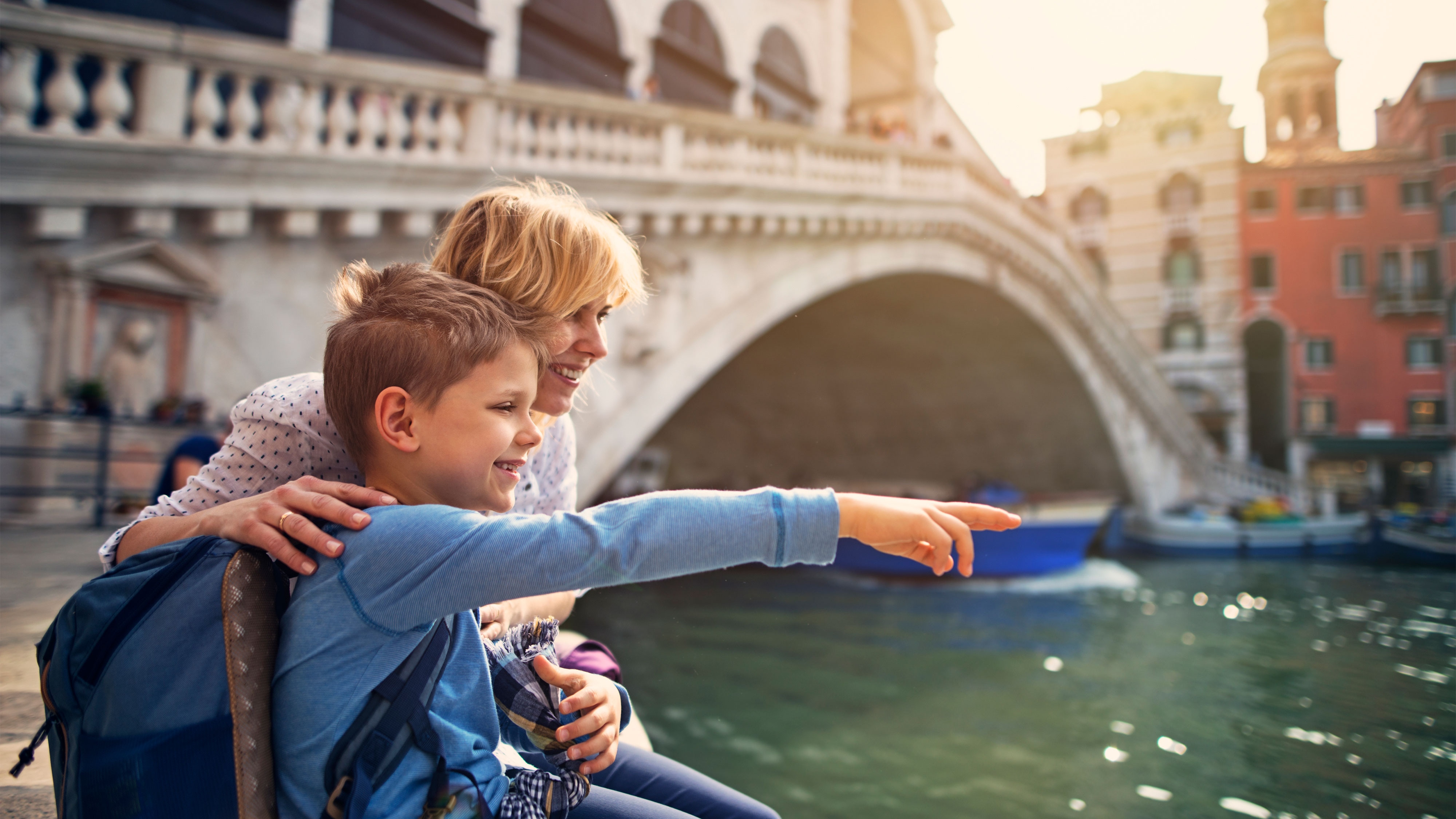 Happy family exploring Venice's Grand Canal