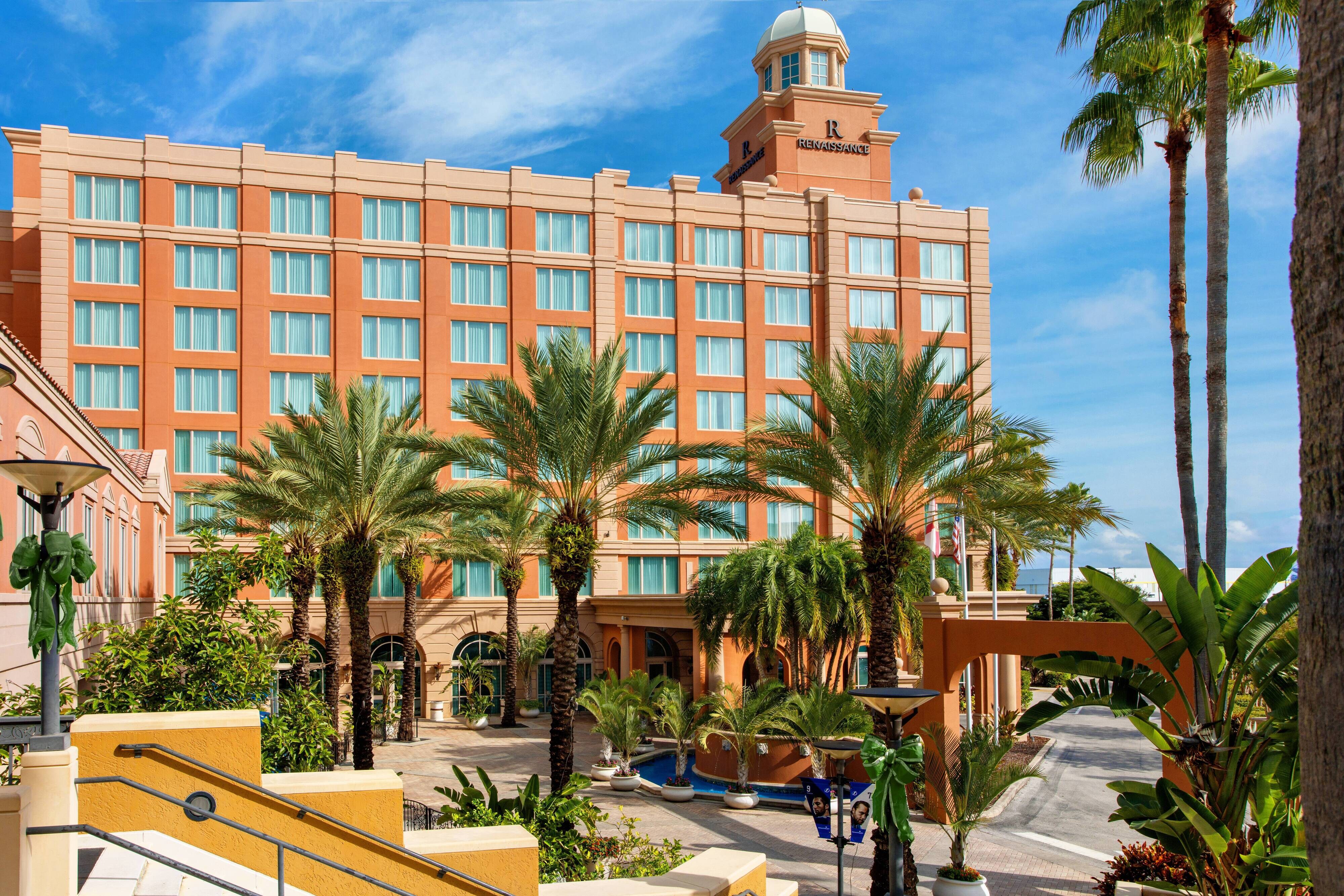 Hotel exterior and palm trees during daytime