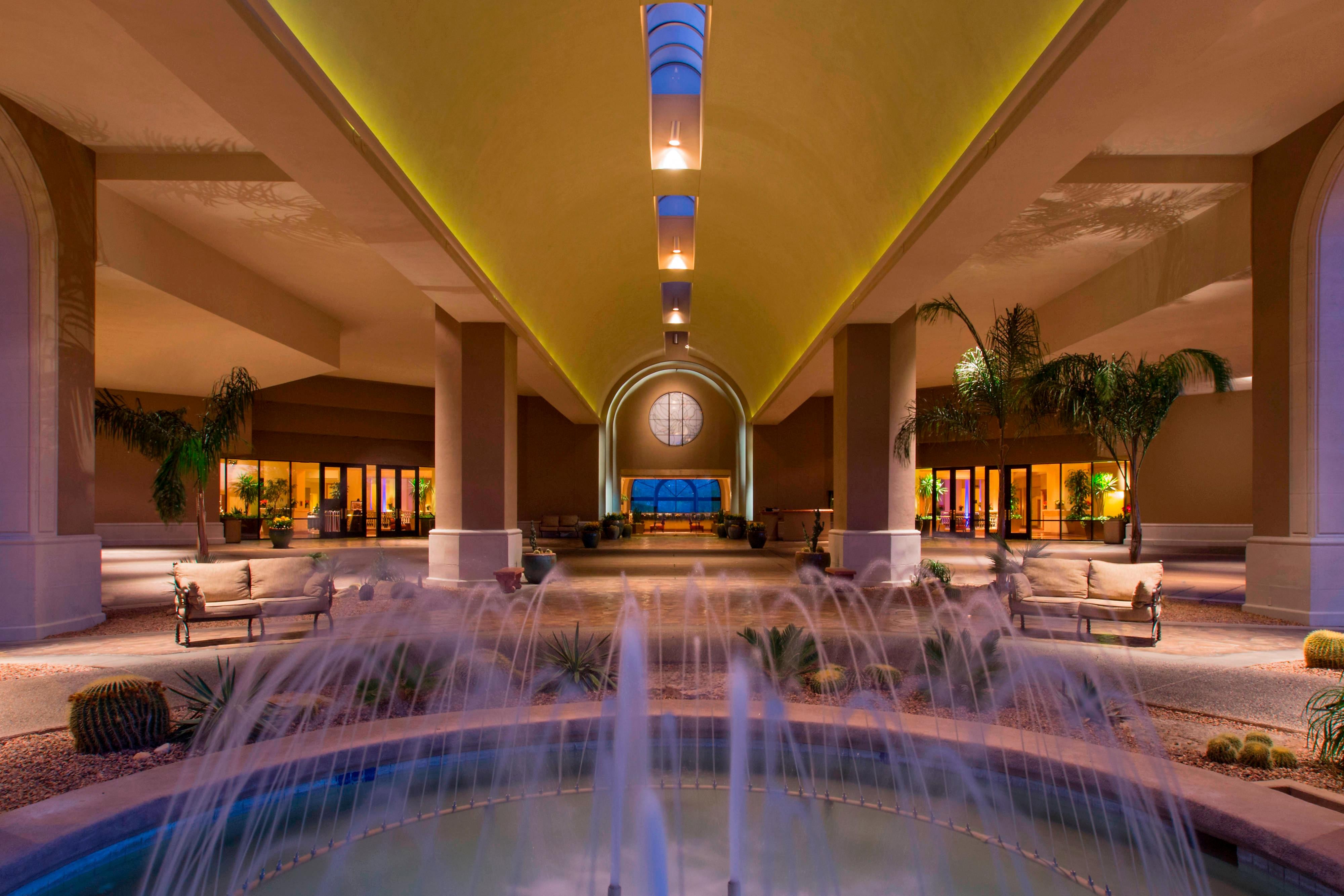 Resort entrance waterfall and palm trees