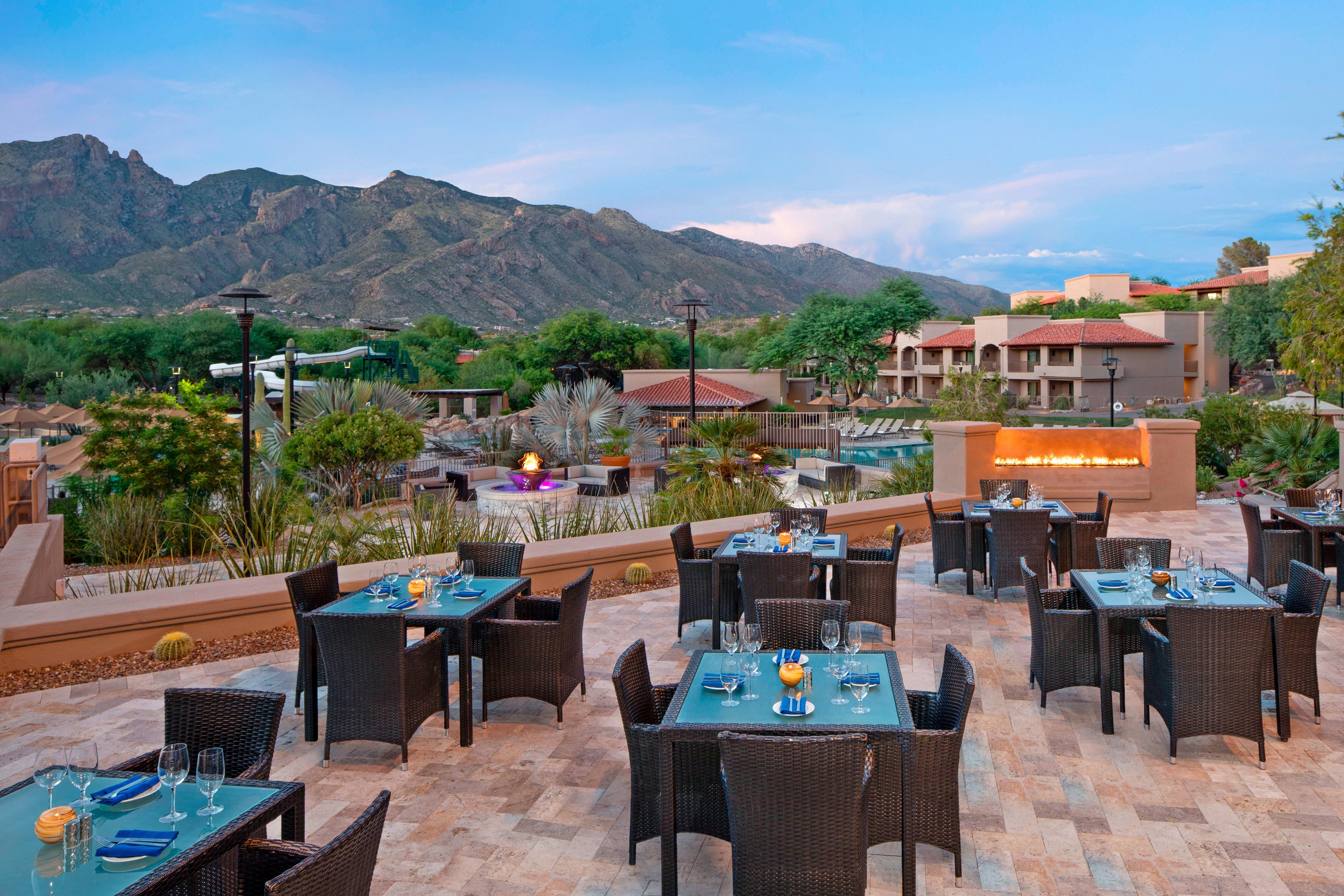 Outdoor dining with view of resort and mountains