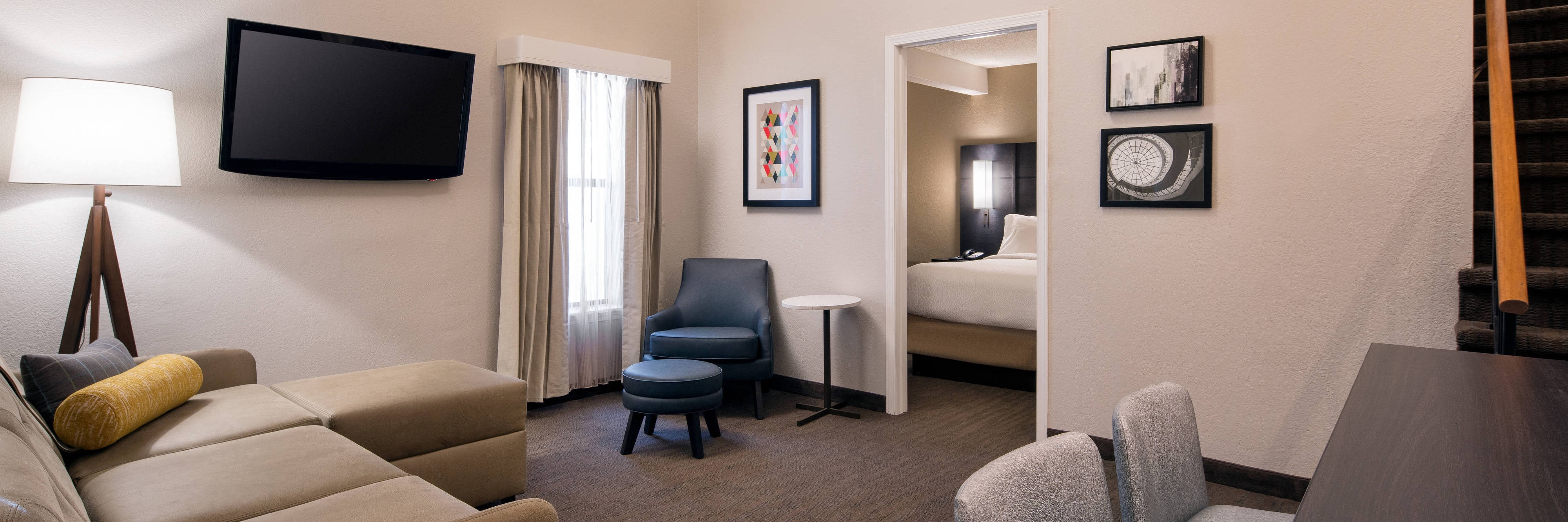 Hotel exterior, courtyard seating area, and outdoor pool