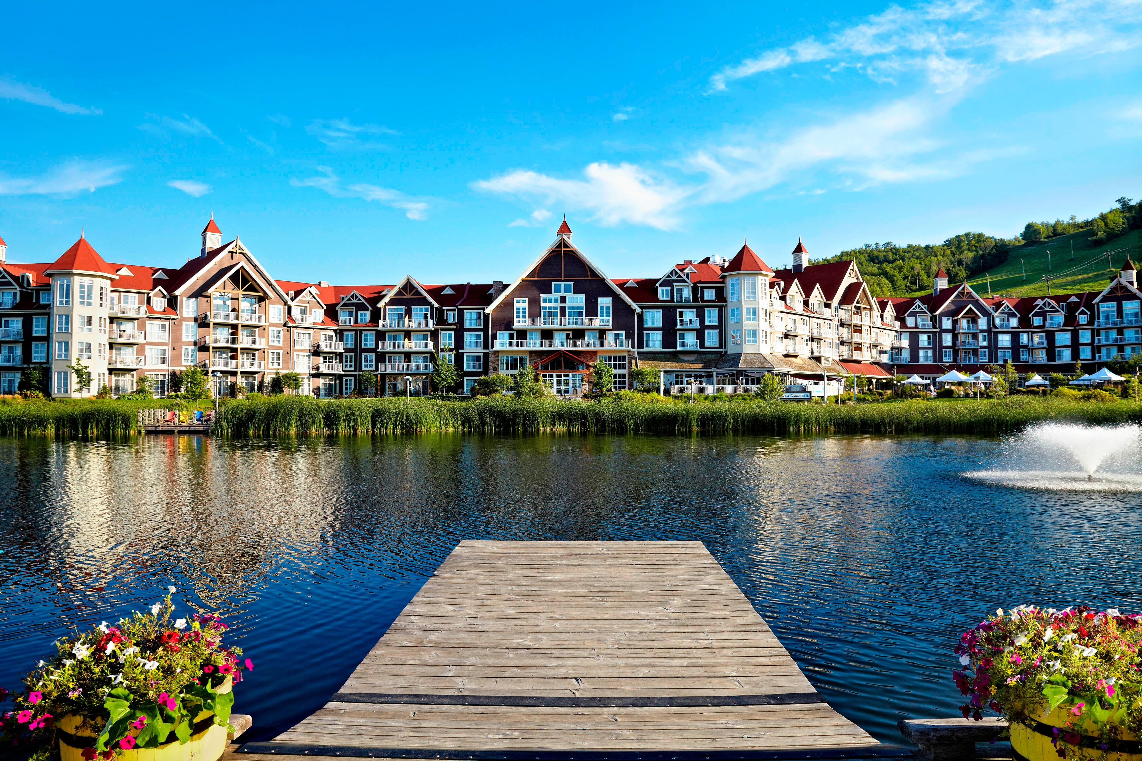 pond and dock with hotel in background