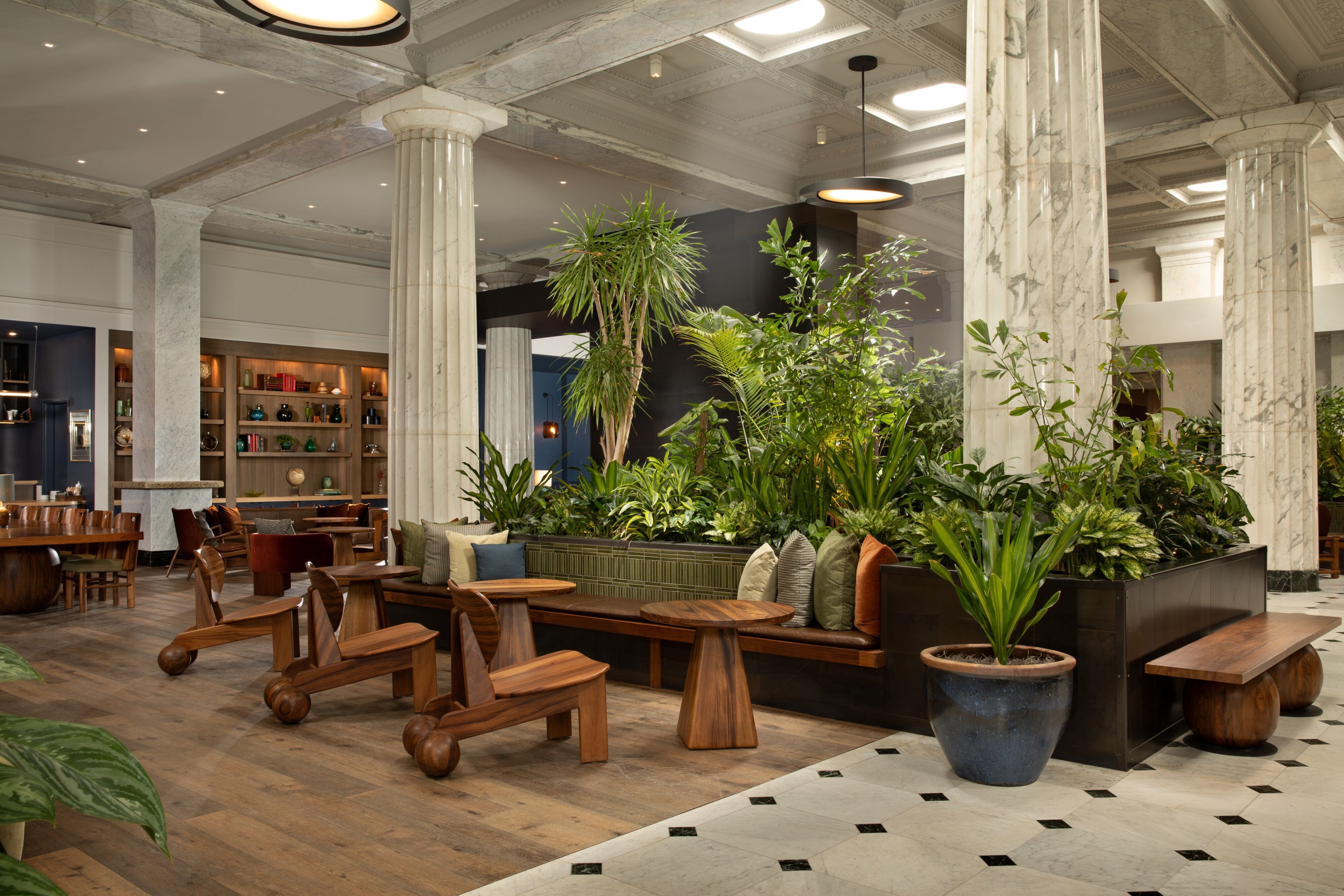 hotel lobby with wooden chairs and plants
