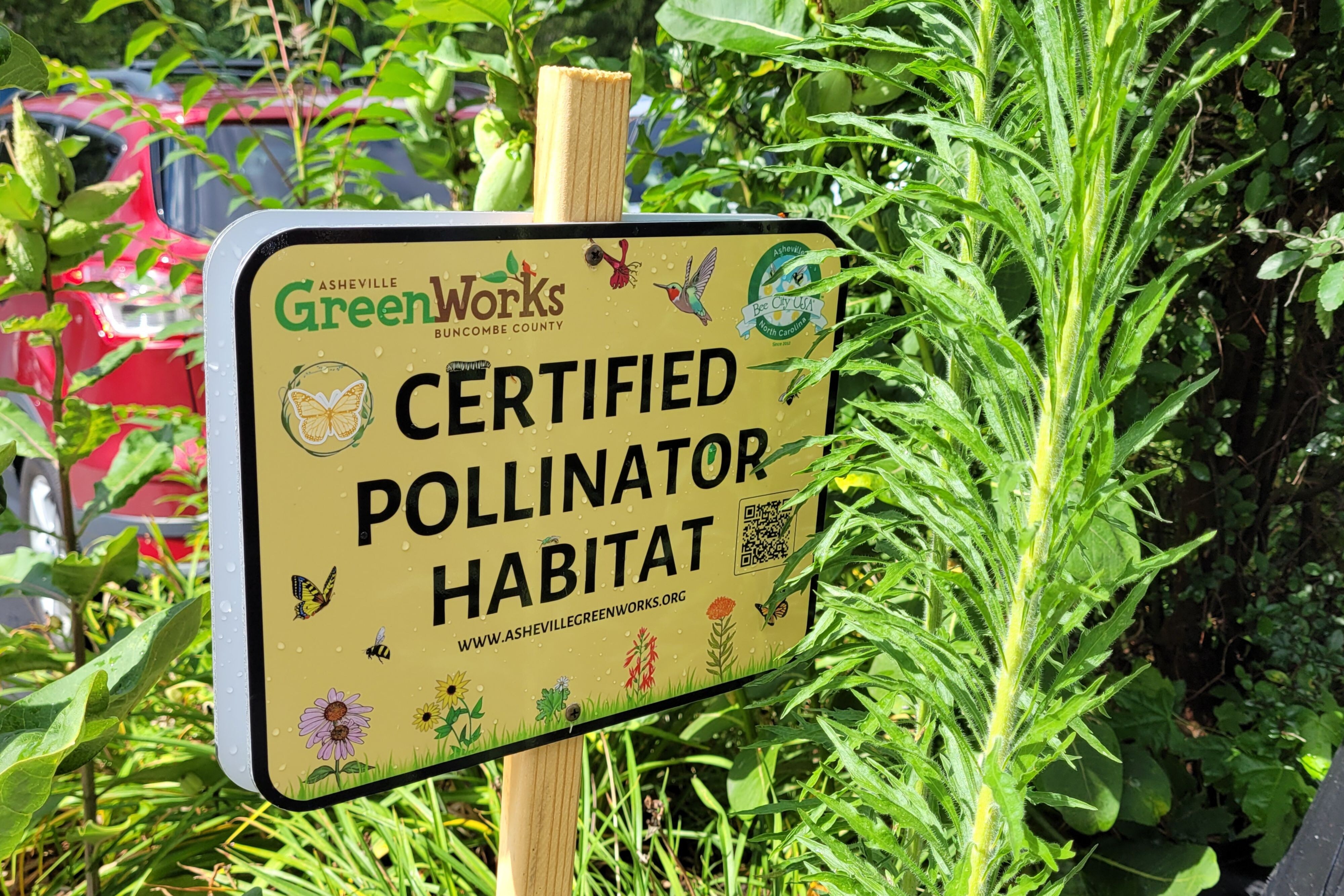 A garden sign stating certified pollinator habitat